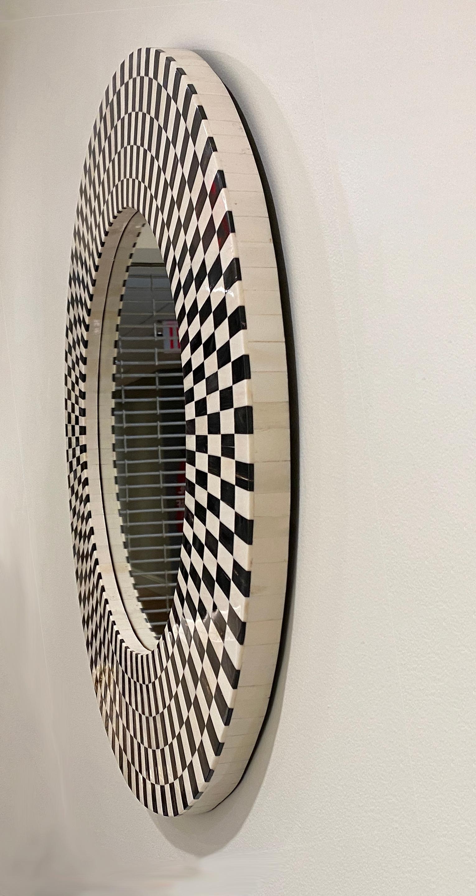 The Kaliedoscope Mirror is a part of the SAND Collection from Farrago Design.
Inspired by the numerous patterns in the Kaleidoscope, this mirror is handcrafted with bone and horn chips. Each bone and horn chip is hand carved and onlaid alternately