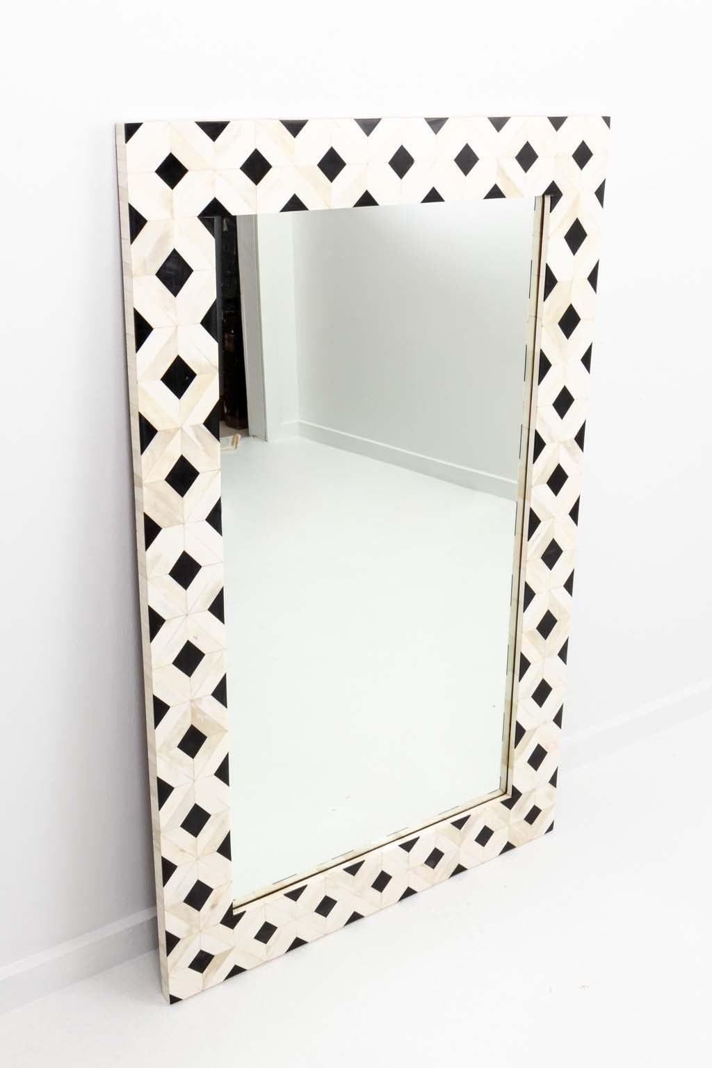 Camel bone and ebonized frame mirror with diamond or trellis form 
pattern. The bold, geometric black and white tessellated design repeats 
throughout.
