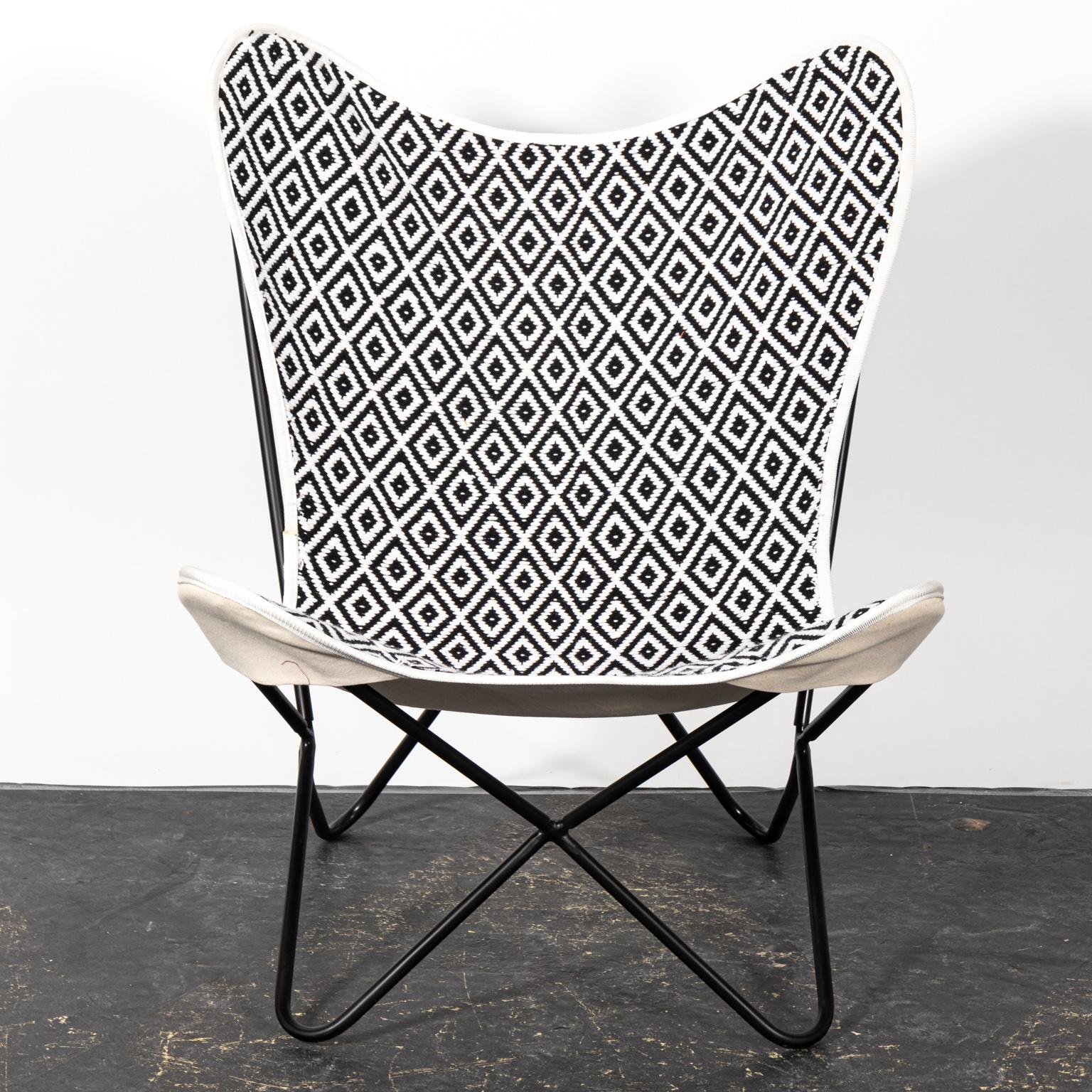 Black and white butterfly chair with diamond patterned upholstery. Please note of wear consistent with age.