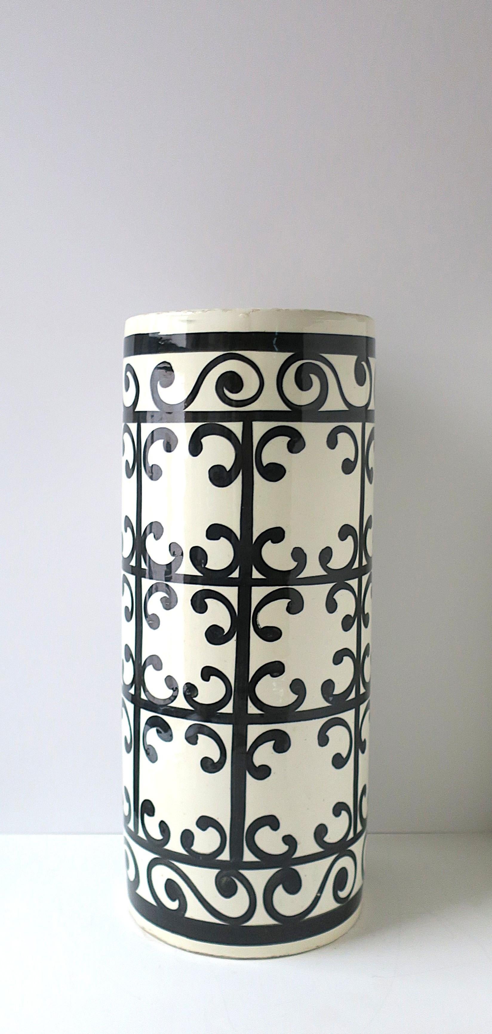 A Spanish black and white ceramic umbrella stand with hand-painted lacework design, circa early aughts, 2000s, Spain. Design depicts the genuine metal work of the wrought-iron balconies of southern Spain. In the style of the 'Balcon du Guadalquivir'
