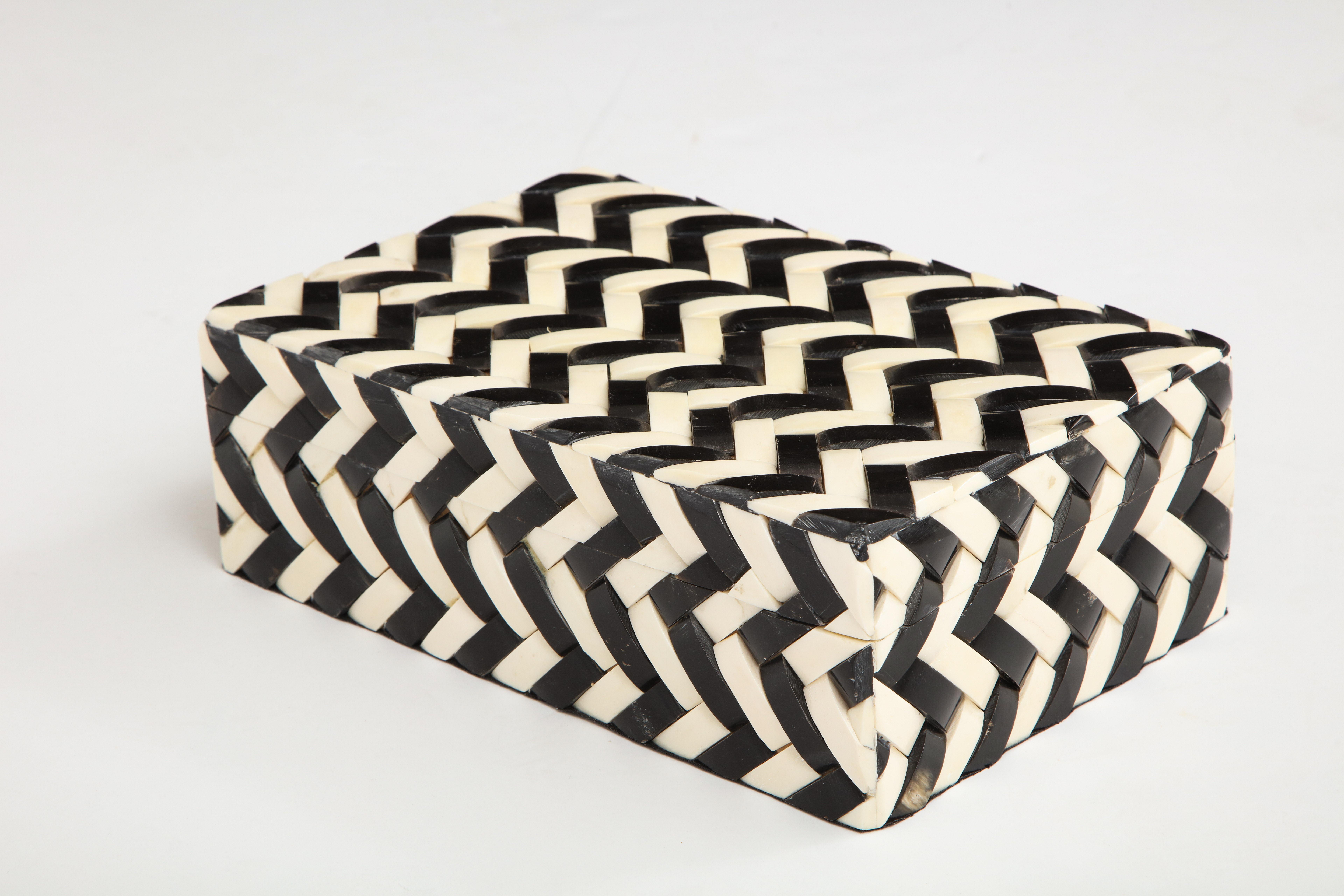 Eye-catching graphic cheveron patterned box made from black and natural bone tiles, lined in wood.