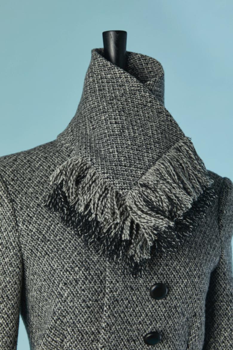 Veste croisée en chiné noir et blanc avec col à franges. Composition du tissu principal : 92% laine, 8% nylon. Doublure en rayonne. Fermeture par bouton et boutonnière + un bouton sur la manchette. 
Pad d'épaule. 
taille 36 (FR) S 