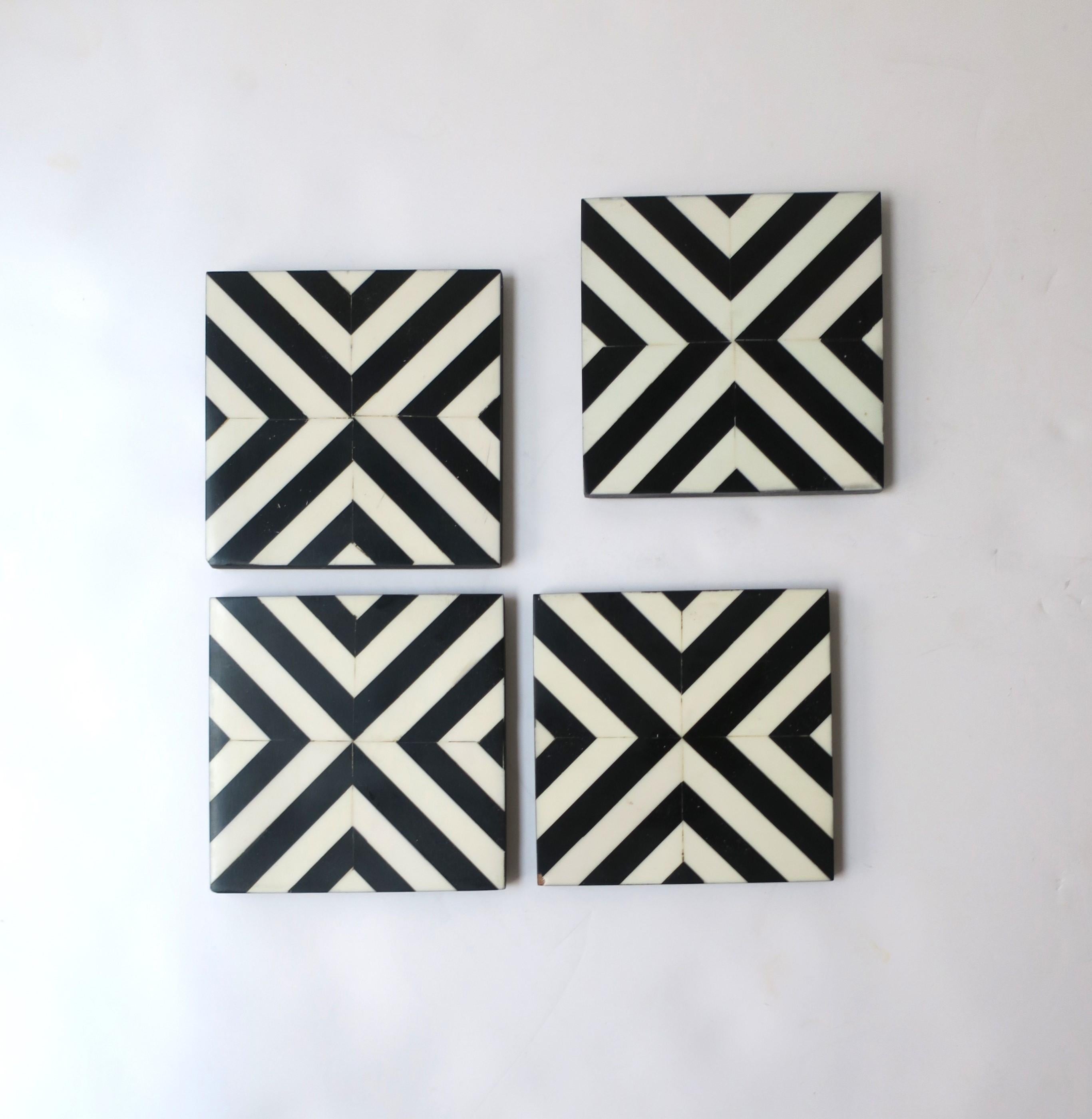 A set of four (4) black and white resin cocktail drinks coasters with a chevron pattern. Coasters are great for any drink including Champagne, wine, water, a cocktail, etc., and are essential for protecting furniture tops. Dimensions: 3.94