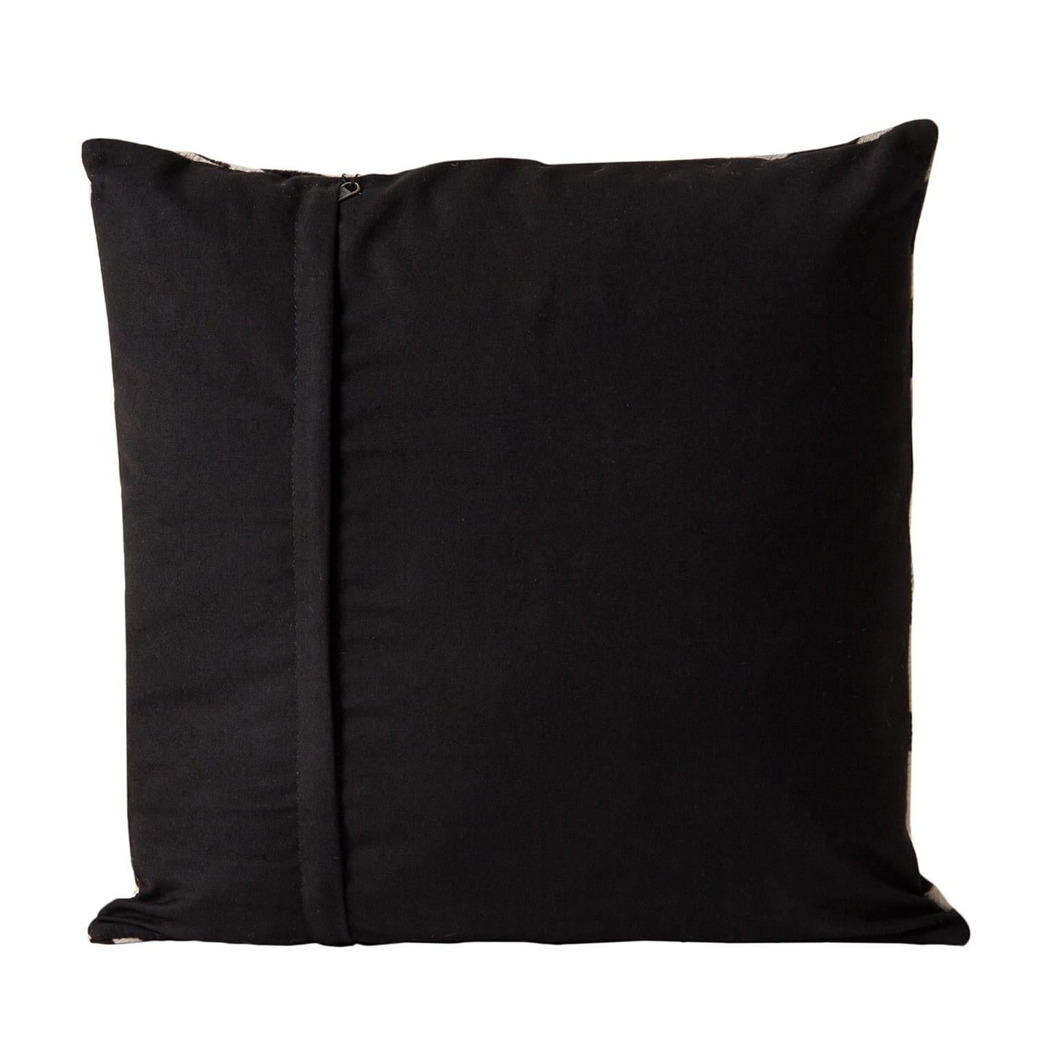 Black and white cowhide cushion.
