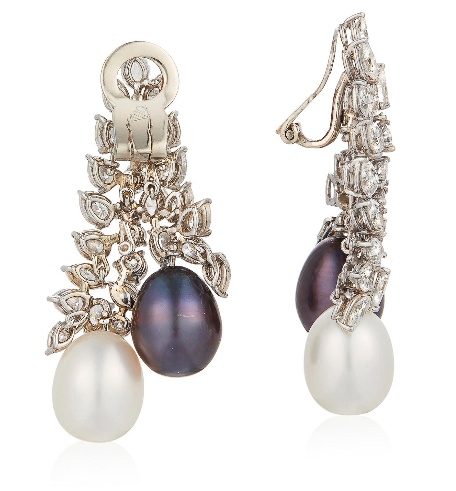 These iconic earrings are set in platinum with 12 round, 14 marquise, and 26 pear-shaped diamonds, weighing approximately 6.50-7 carats. The diamonds vary from H - J color with SI clarity

The diamonds are accented with black and white, perfectly