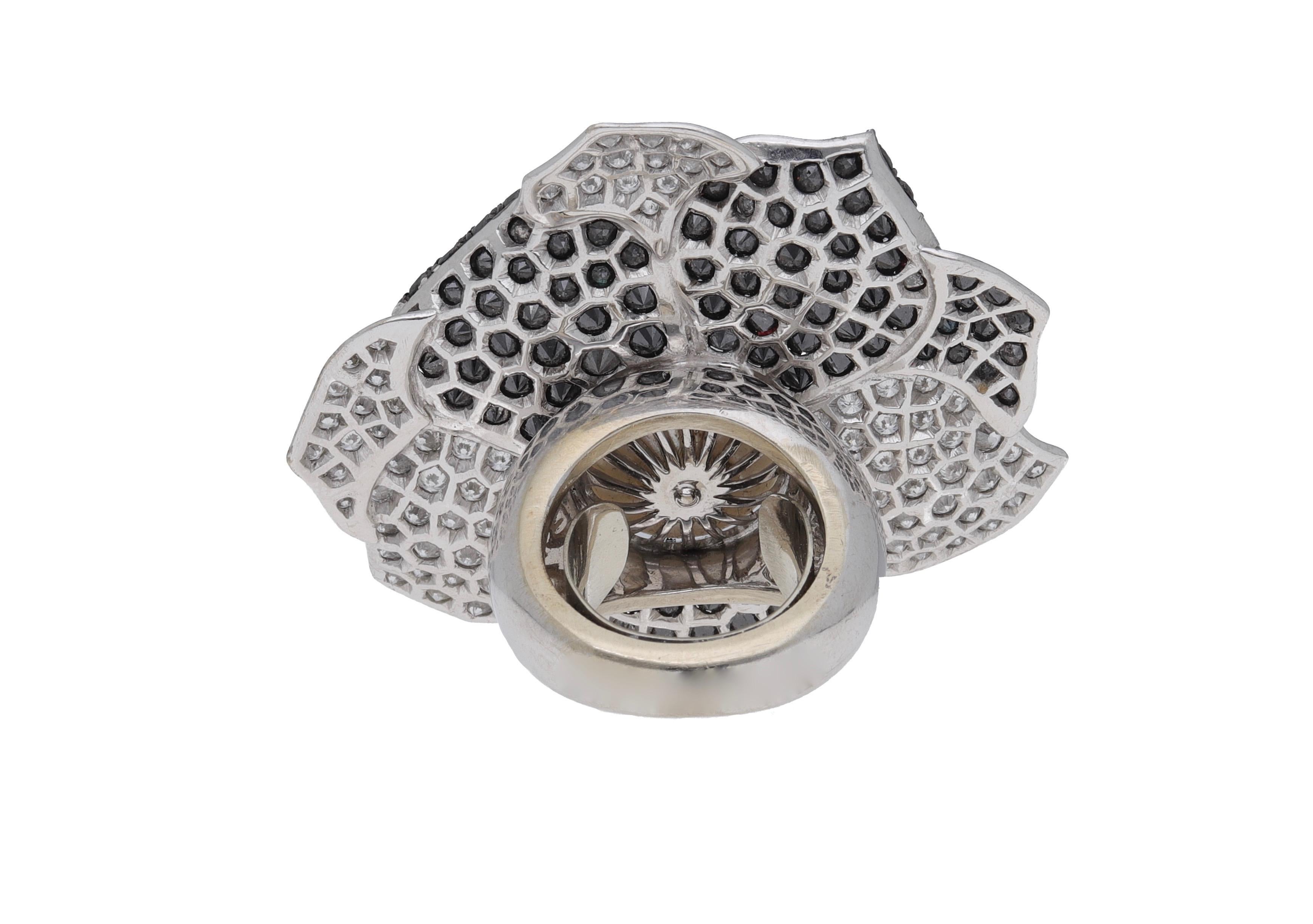 18 Kt. white gold ring with black & white diamonds and South sea round pearl.
This impressive ring is designed as a flower.
Black diamonds: 7.00 carat
Diamonds: 6.00 carat 
South sea pearl: 16 mm. 
This ring is completely hand-made in Italy and has