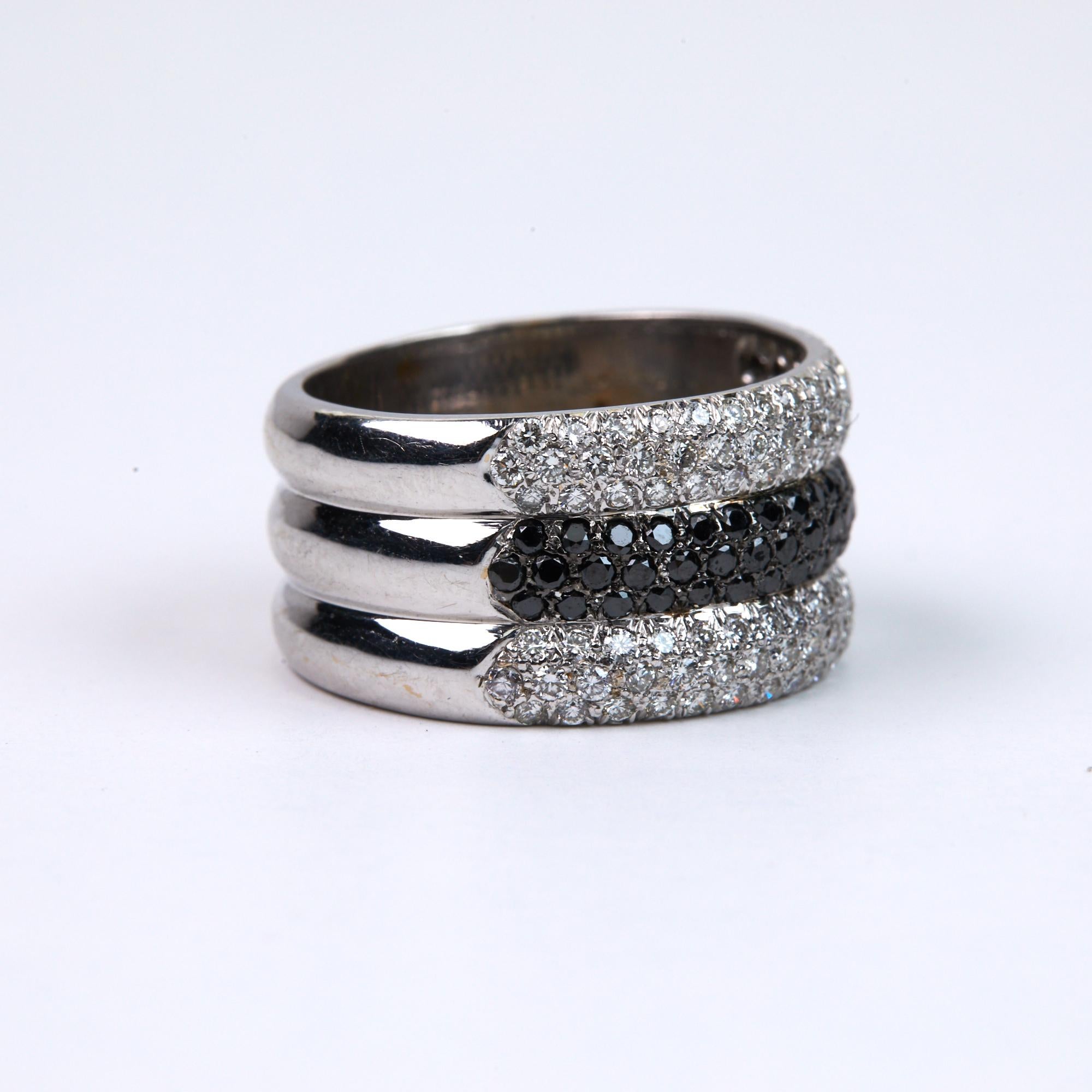 Black and White diamond Band Ring with 1.95 carats of Diamonds set in 18 karat white gold.  The white diamonds are all F-G in color and VS clarity.  All diamonds are Excellent cut, polish and symmetry which gives this ring a beautiful sparkle. One