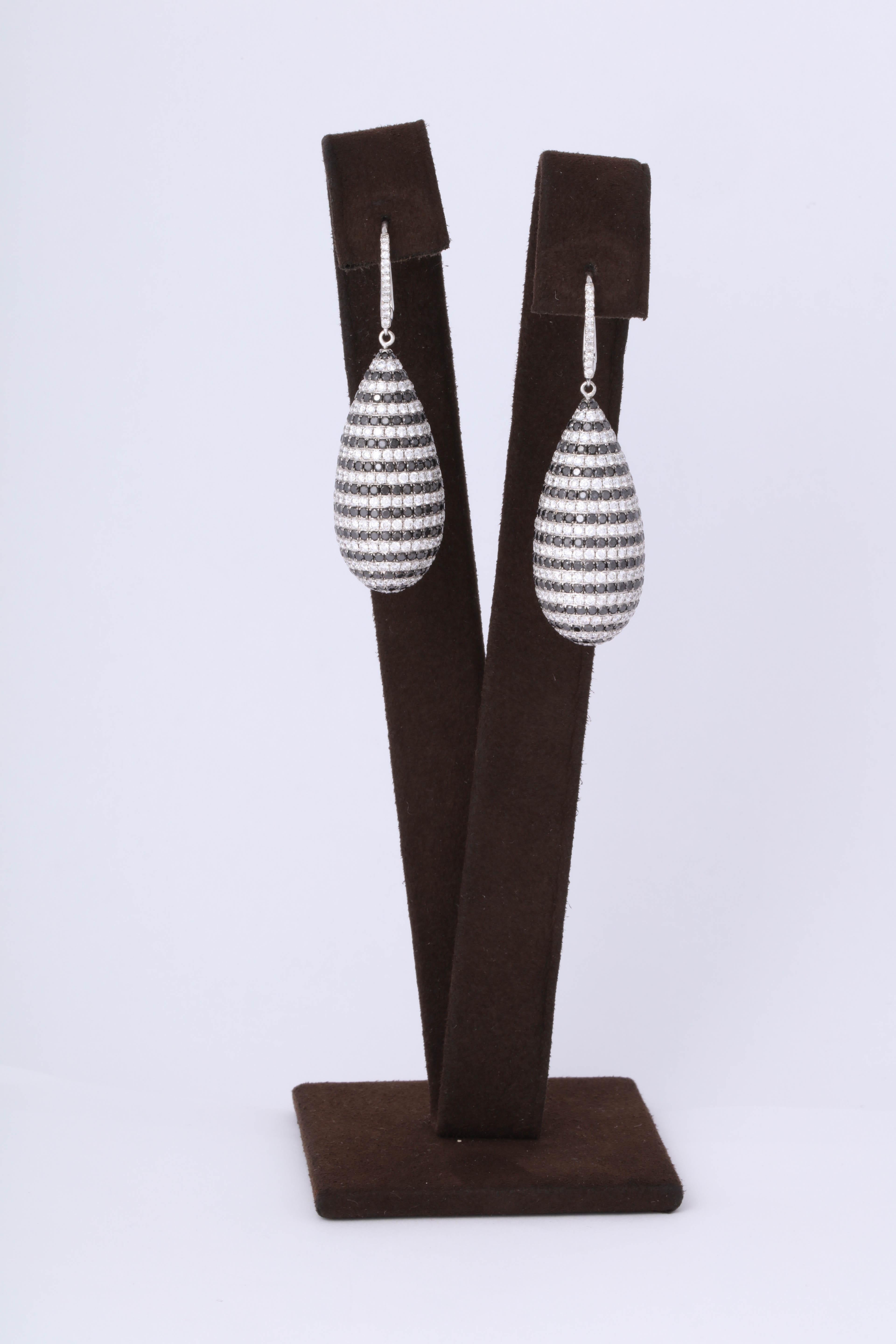 

A unique pair of fashionable diamond earrings.

13.54 carats of black and white diamonds set in 18k white gold. 

The earring is constructed in a dome shape and it is completely covered in black and white diamond sparkle!!

Slightly over two