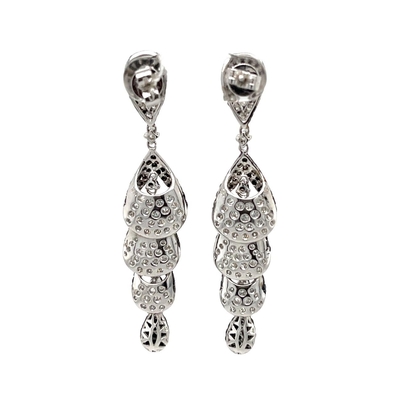These stunning dangling earrings are surrounded with 272 Black Diamonds and 136 brilliant cut round White Diamonds and set in 18K white gold. These earrings are 2.25 inches in length and will be the talk of the event! They have double lock closure