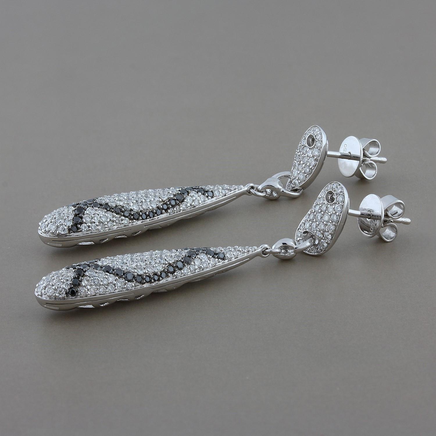 A pair of creative earrings for the night out. These elongated pear shape drop earrings feature 2.67 carats of round brilliant cut diamonds set in 18K white gold. 

Earring Length: 1.95 inches
Earring Width: 0.25 inches