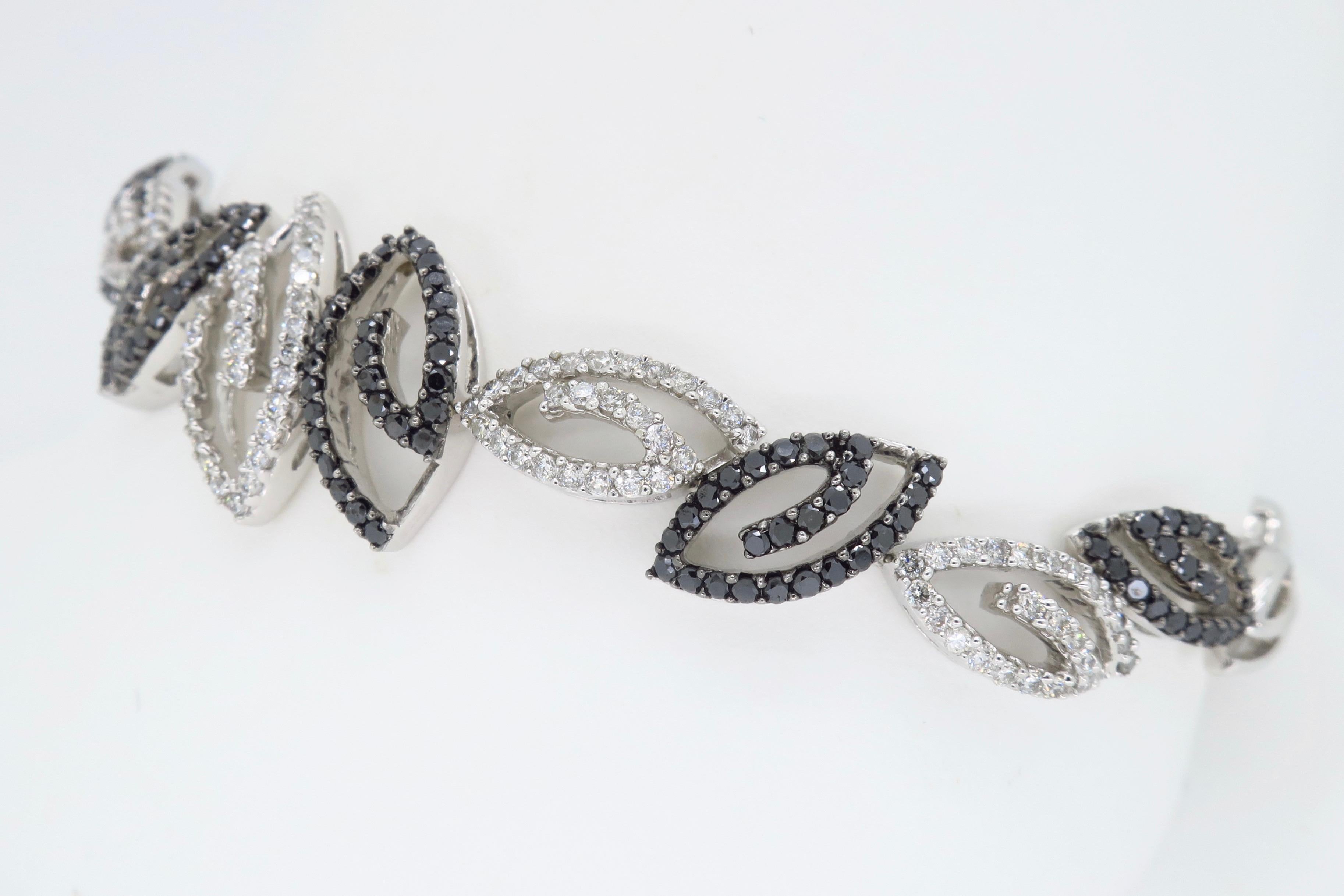 This diamond bracelet is encrusted with approximately 1.75CTW of Black and White Diamonds set into a elegant and unique design.

Diamond Carat Weight: Approximately 1.75CTW 
Diamond Cut: Round Brilliant Cut Diamonds
Color: Approximately .75CTW of