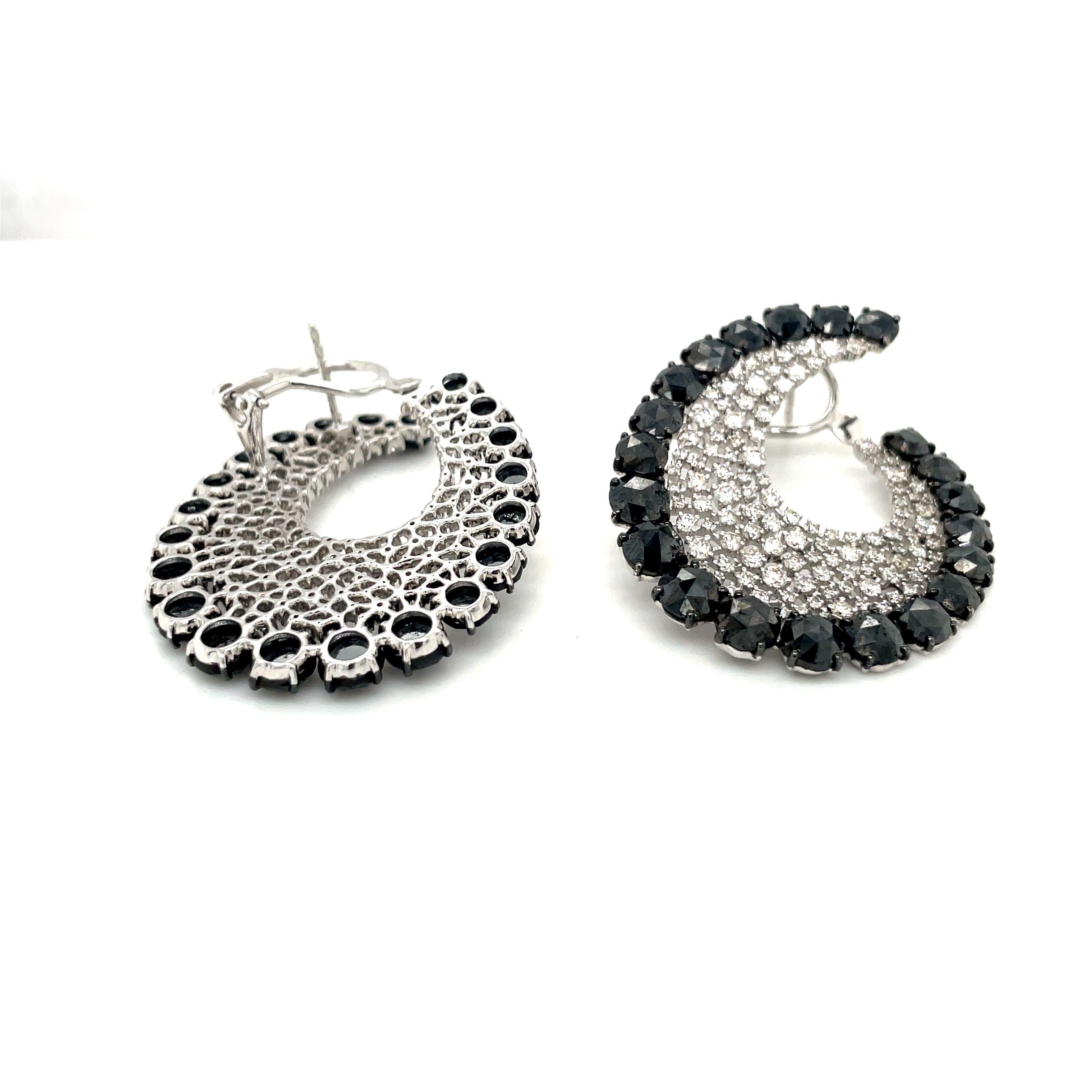 These Scintilla earrings by Sutra feature a delicate web of round brilliant white diamonds edged with rose-cut black diamonds, set in 18-karat blackened white gold. Black and white diamonds total 18.84 carats. Earrings are approximately 1.25 inches