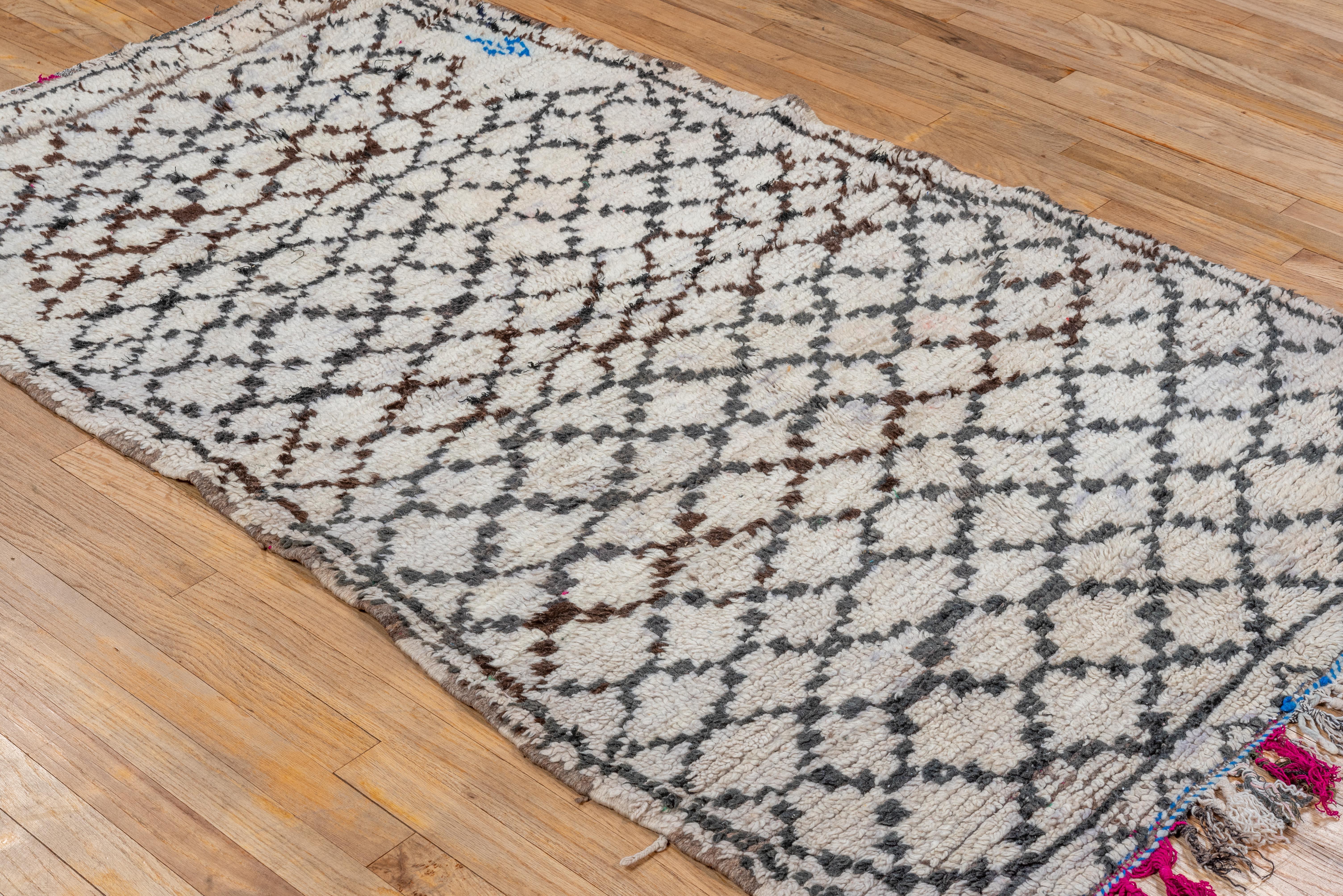 Showing signs of light use throughout, this diamond pattern rug from Moroccan made entirely of wool is a wonderful addition to any bedroom, water closet or studio space. 