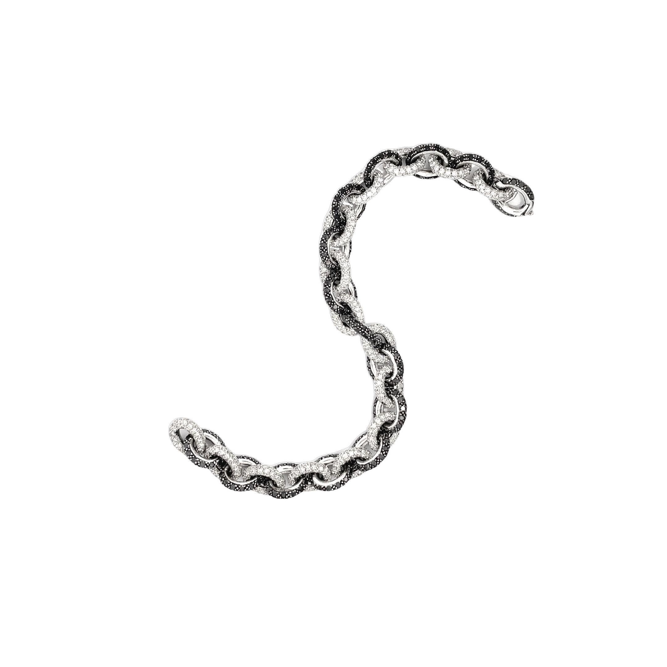 This exquisite diamond bracelet makes a stunning jewelry statement. Crafted from lustrous 18-karat white gold, it features a continuous chain of interconnecting links that form a seamless and sophisticated band. Wrapping around the wrist, each link