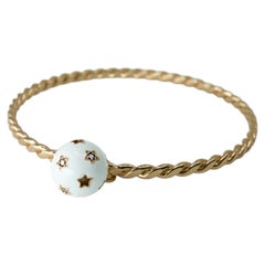 Bracciale rigido con sfere a forma di stella con diamanti bianchi e neri, smalto bianco