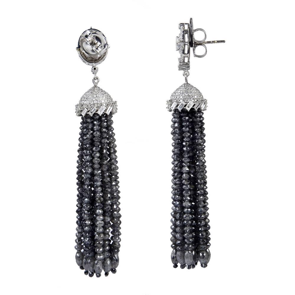 Add a classy touch to any attire with this lovely pair of black and white diamond tassel earring set in 18K white gold with round pave diamonds and baguettes. 
Closure: Push Post

18K:10.24g,
Diamond: 86.26cts