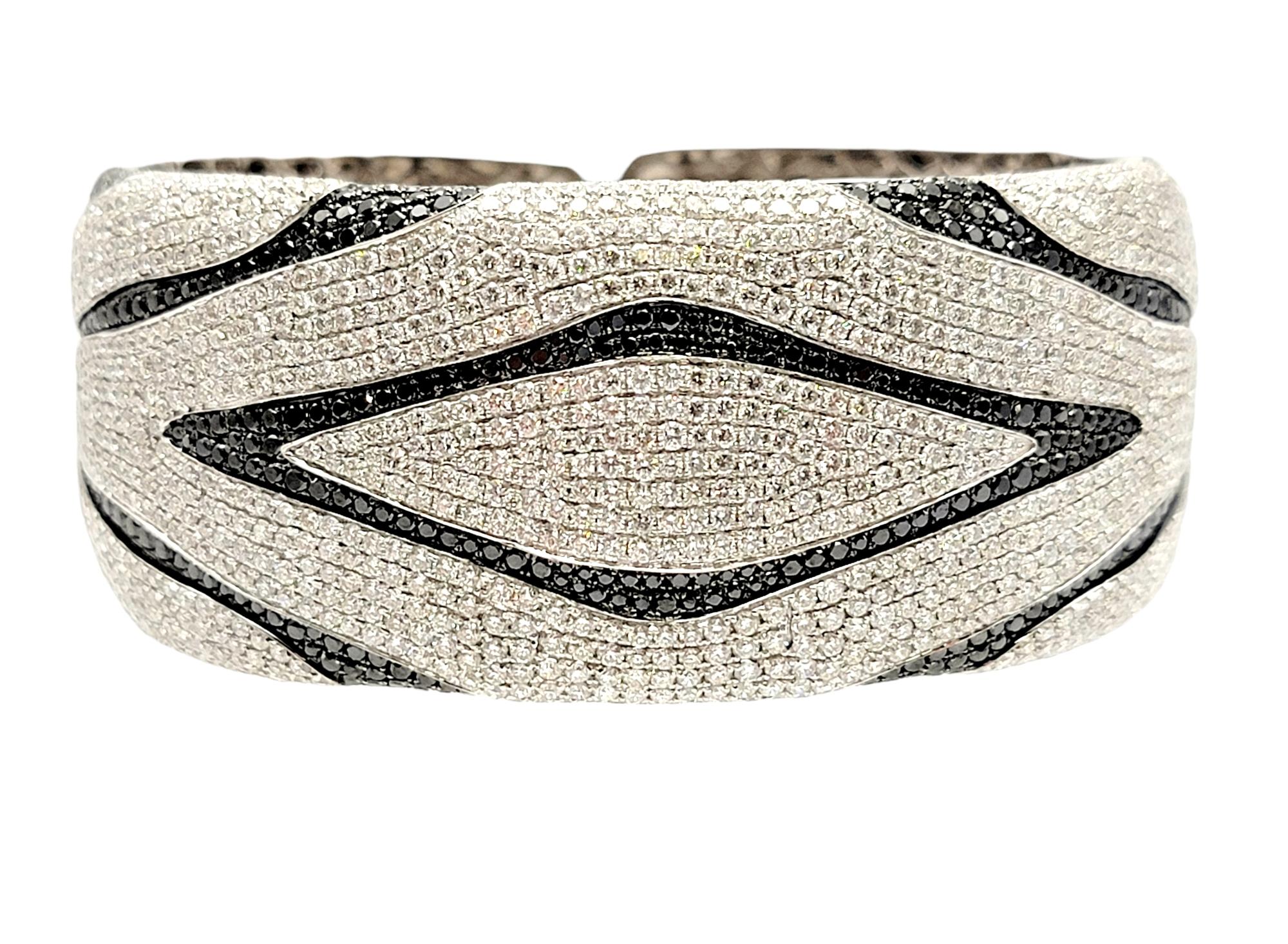 This is an absolutely stunning 13.00 carat black and white pave diamond cuff bracelet with a geometric zebra style pattern.  This is an exquisite, elegant piece that really sparkles on the wrist. 

It features an impressive 849 sparkling white pave