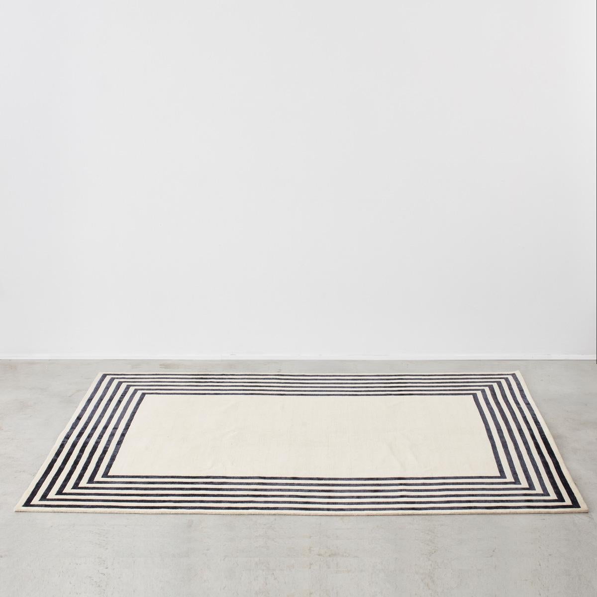 A restrained monochromatic carpet with recursive black geometric pattern. Ideal for minimalist interiors. Sourced in Italy, most likely handwoven in Indo-Nepal. Material: wool.

Price includes VAT, not applicable for export sales (we ship from the