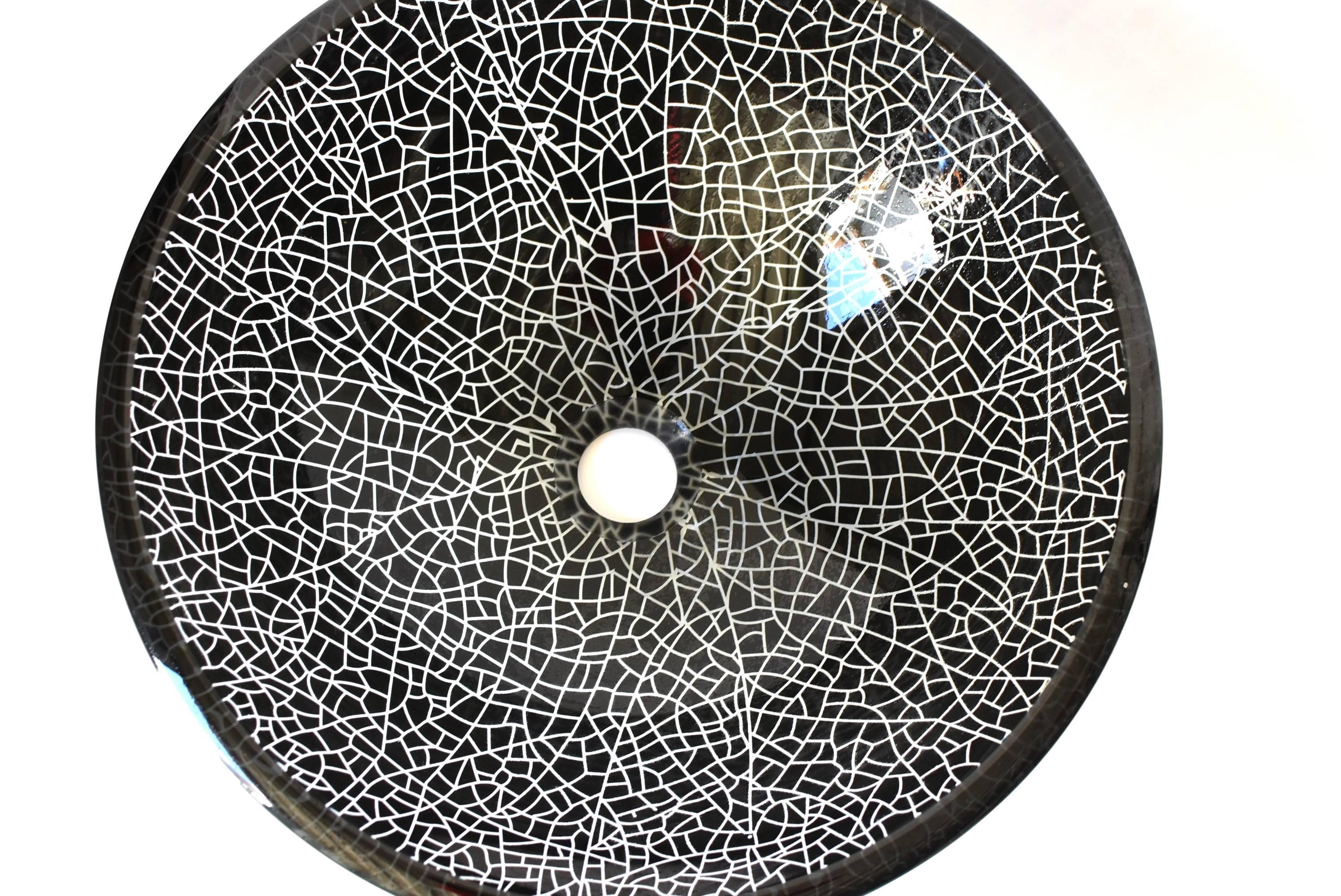 Beautiful black and white glass sink with a crackle pattern. The sink is heavy and substantial, rings like crystal. The crackle pattern adds a modern touch to the piece. The bowl is glass, wider, lower height provides extra comfort. One of a kind.