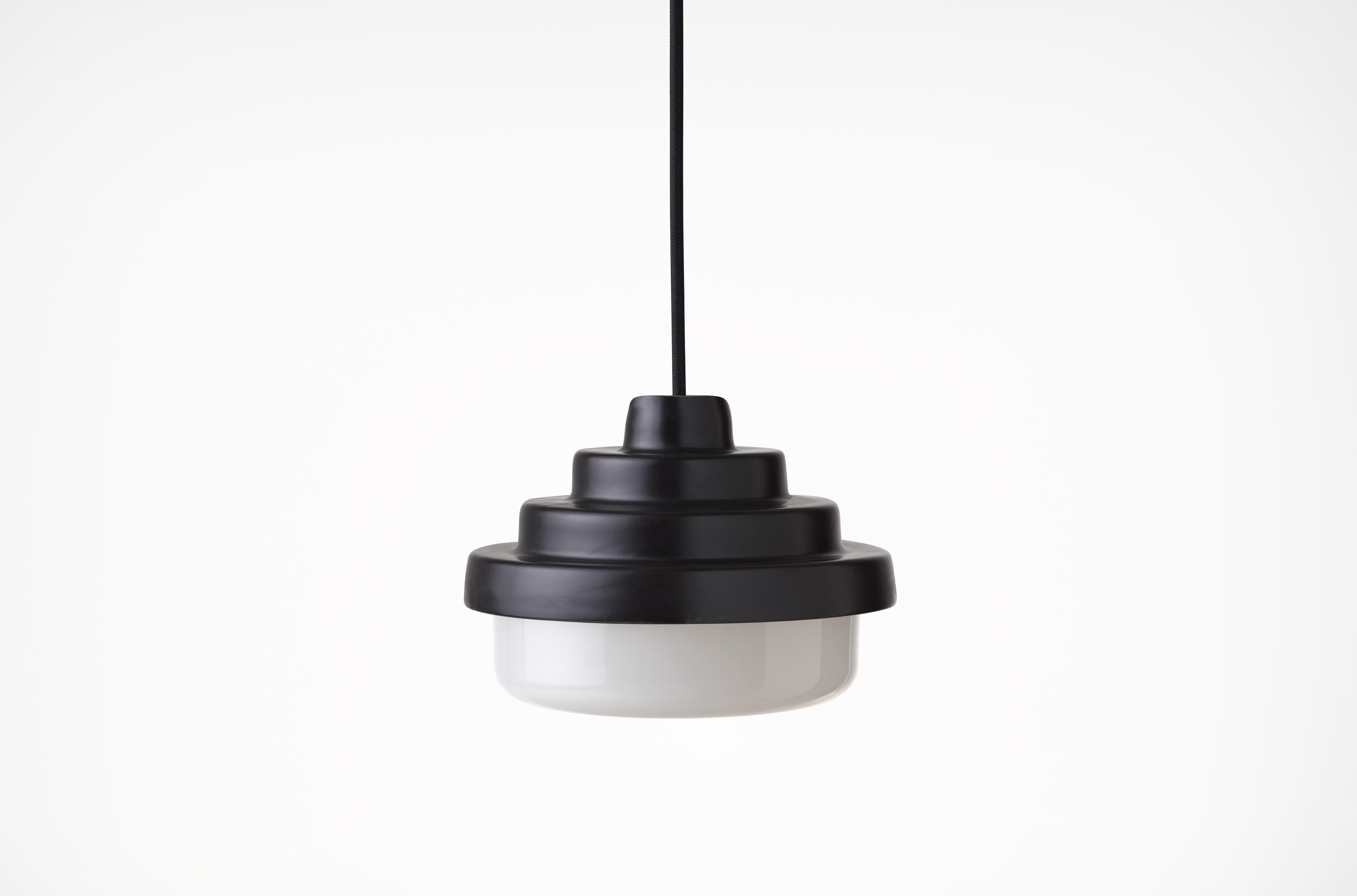 Black and White Honey Pendant Light by Coco Flip
Dimensions: D 18 x W 18 x H 13 cm
Materials: Slip cast ceramic stoneware with blown glass. 
Weight: Approx. 2kg
Glass finishes: White
Ceramic finishes: Black satin glaze. 


Coco Flip is a Melbourne