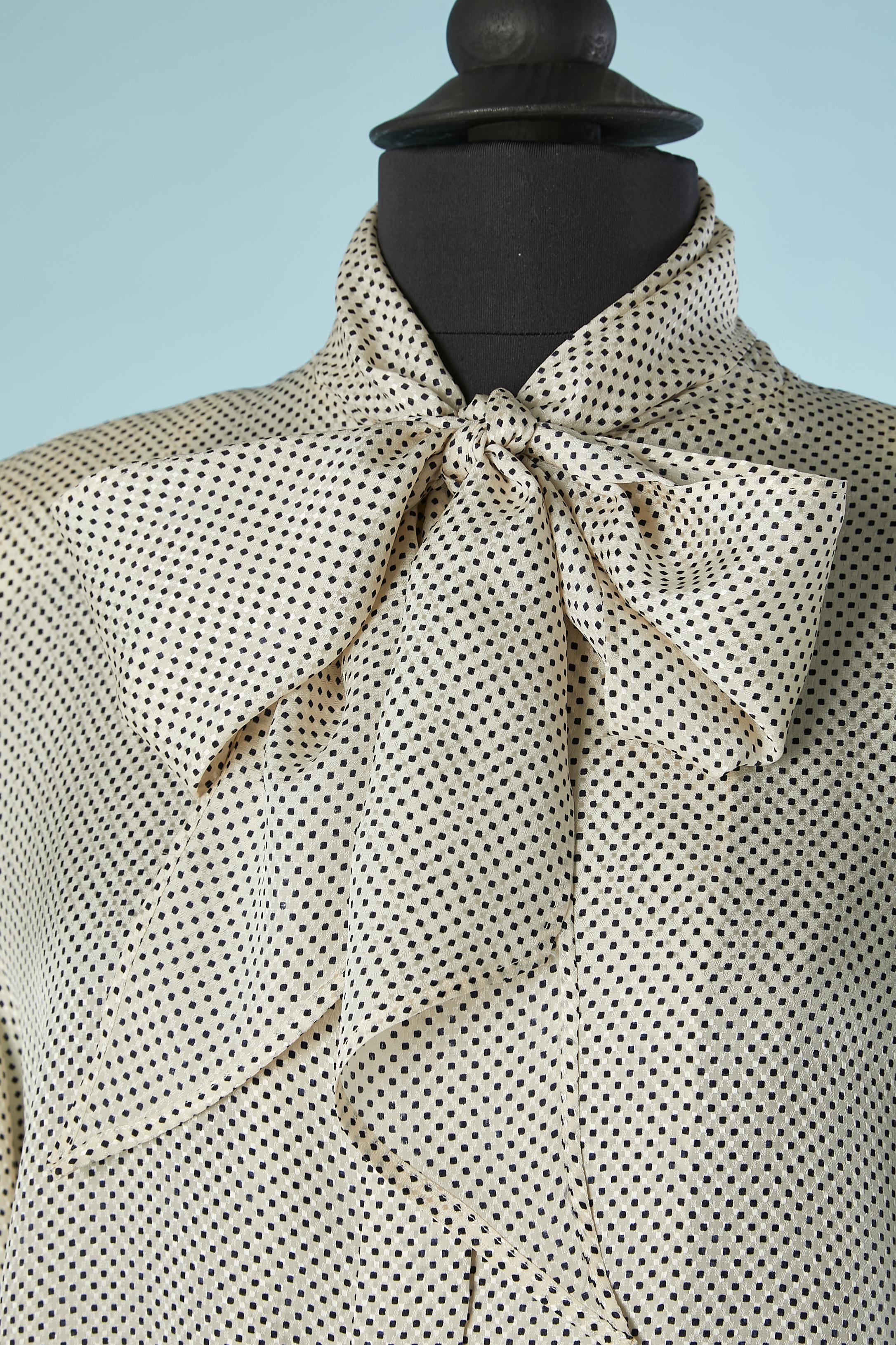 Black and white jacquard silk shirt with bow-tie collar. Shoulder-pads. Extra button provided. 
SIZE 44 (Fr) 14 (US) L 