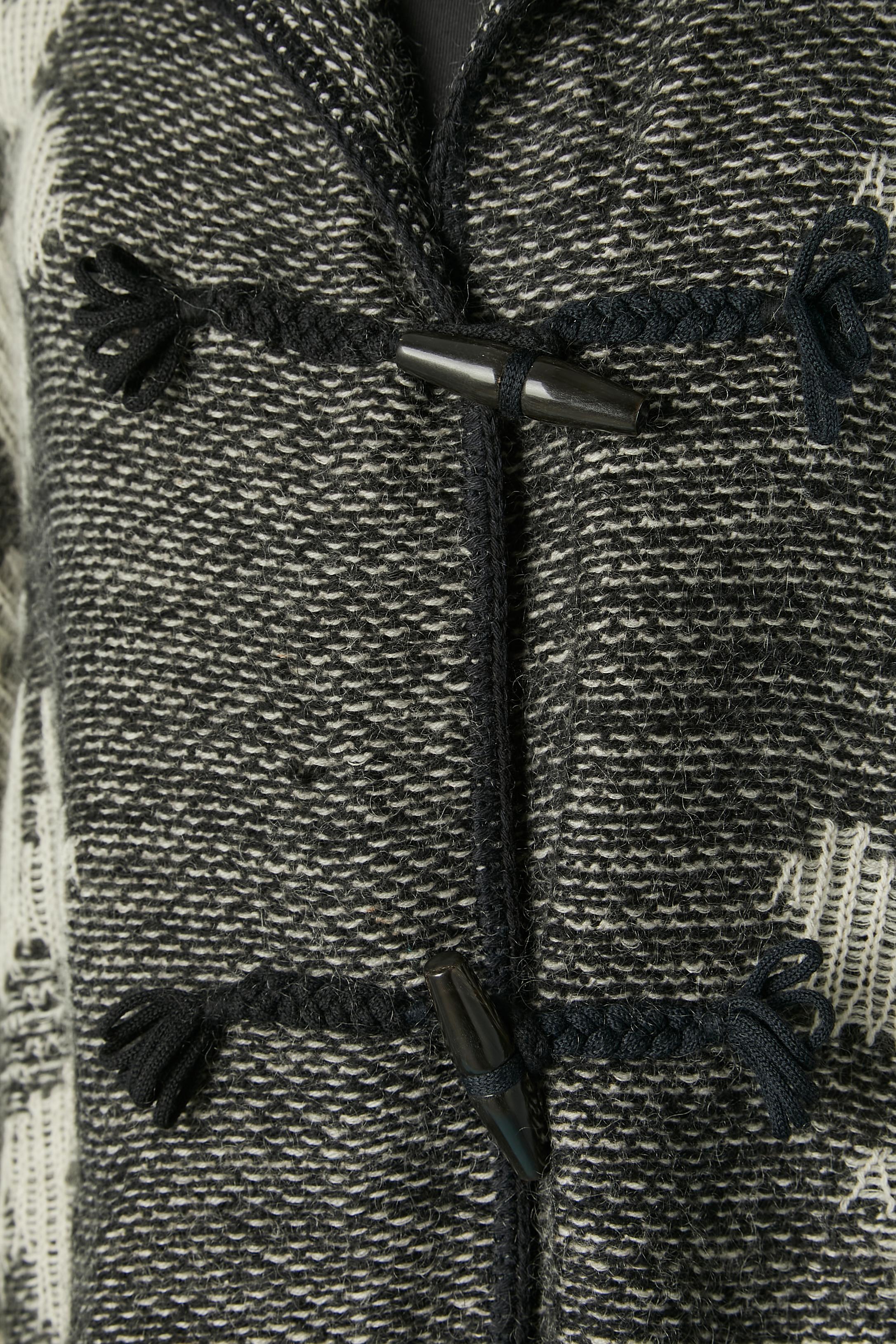 Black and white knit jacquard coat with hood. Knit composition: 85% wool, 6% mohair, 9% nylon. 
Button and cotton braid buttonhole on the middle front. 
SIZE XL or Oversize