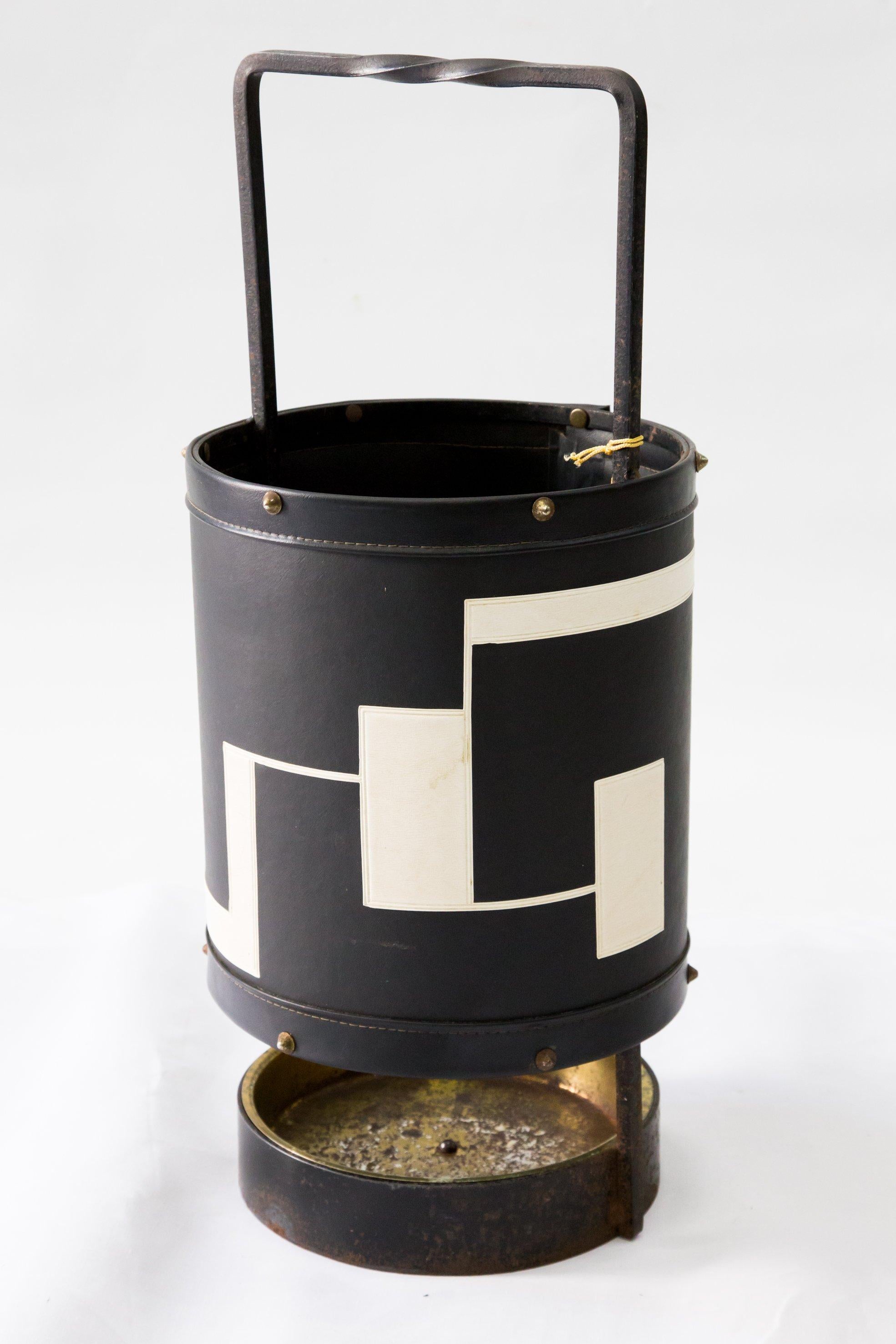 1950s-1960s era leatherette and iron umbrella stand in black and white color.
This vintage item remains fully functional, but it shows sign of age through scuffs, some rusting and fading of material.