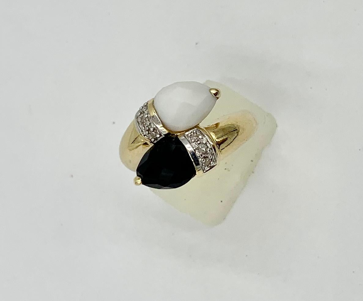 A classic Retro Ring with Black Onyx and White Onyx faceted pear shape gems.   The vivid Onyx is accented by 6 sparkling white Diamonds.  I just love the dramatic black and white Onyx together with the diamonds.  The jewels are set in 14 Karat