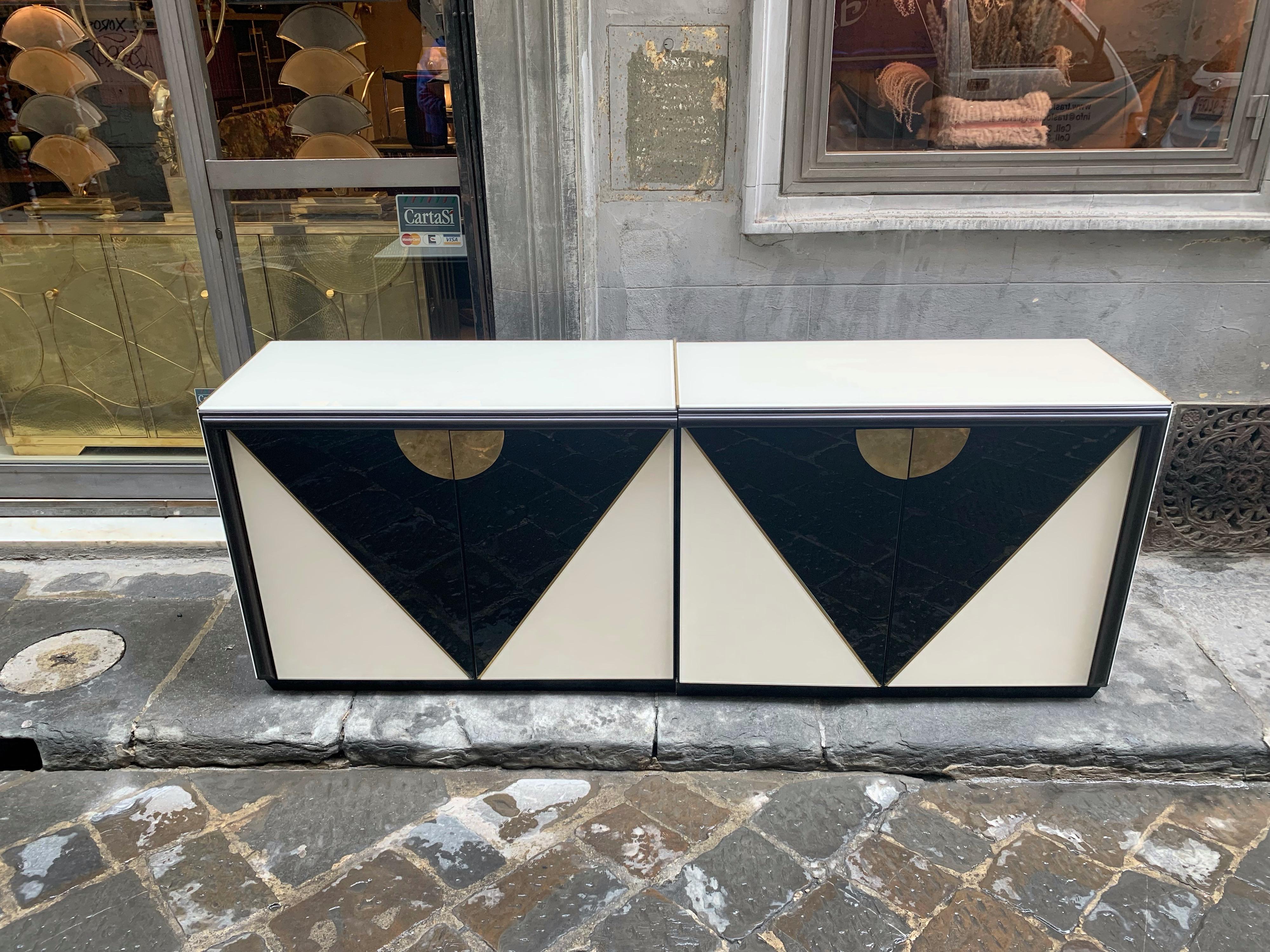 Black and white opaline glass credenza with geometric design.
The sideboard is made up of two pieces joined together by internal screws, each piece comes with two doors with a shelf inside.
The piece can also be placed in the center of the room
