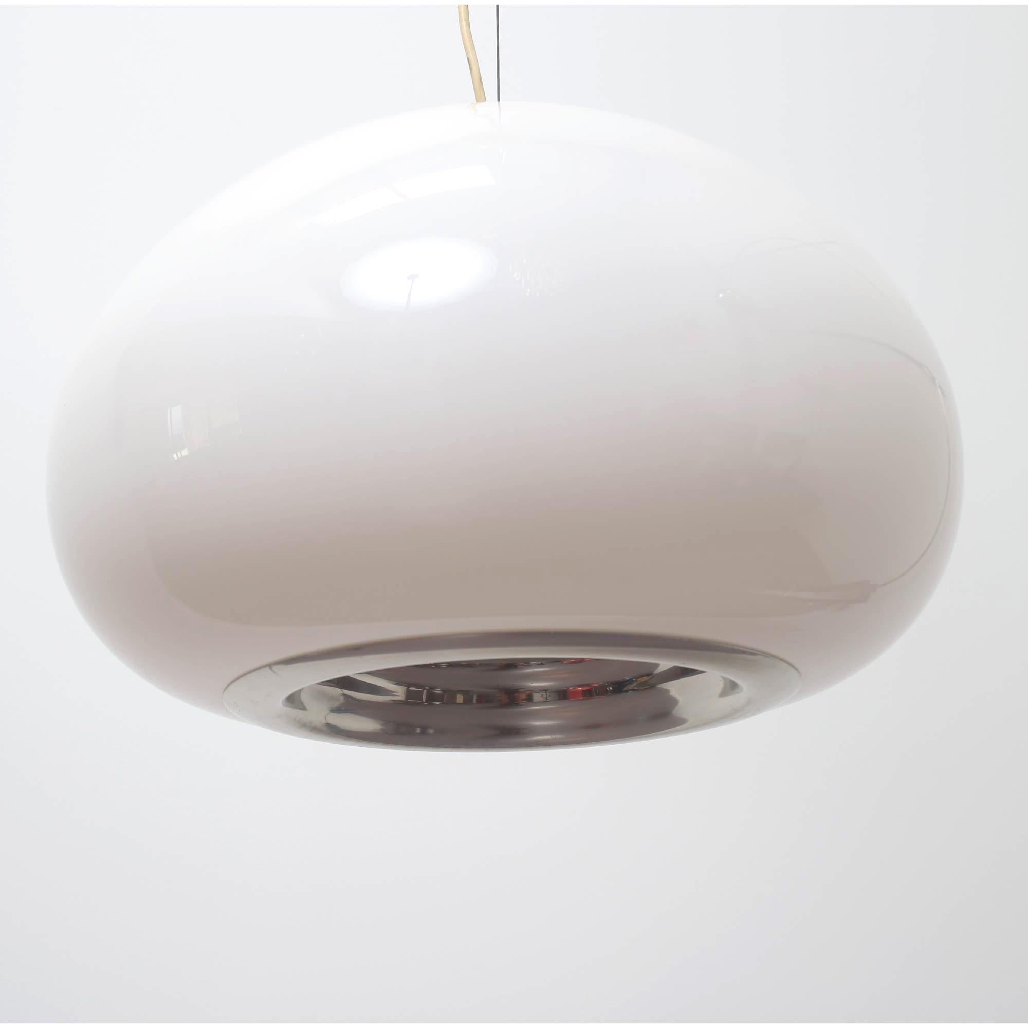 Ceiling lamp designed in 1965 by the Castiglioni brothers. Produced by Flos. It produces diffused light through the opal glass diffuser and concentrated light with a polished aluminum reflector.