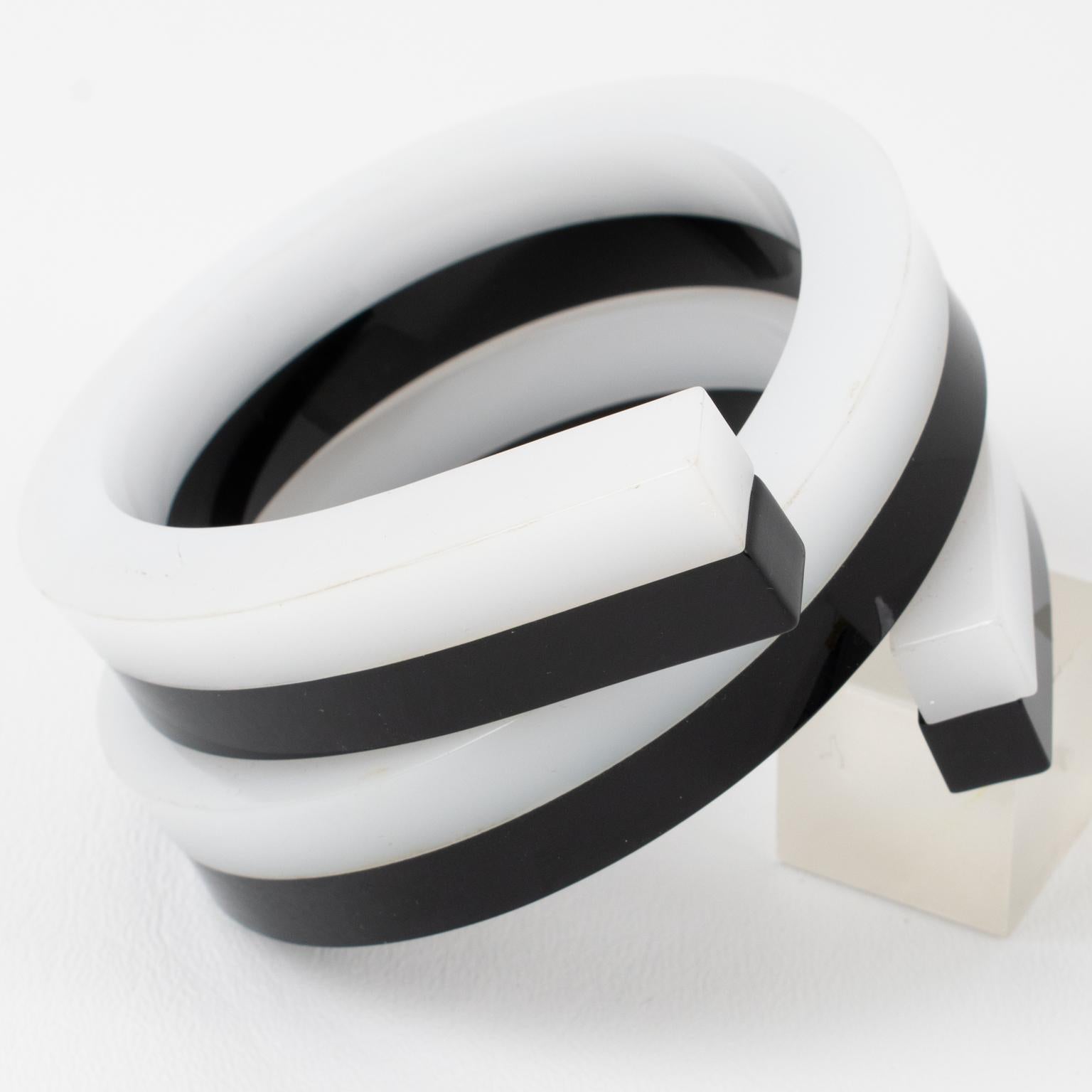 This stunning oversized Space Age sculptural Lucite bracelet bangle features a chunky coiled-wrapped shape with squared 