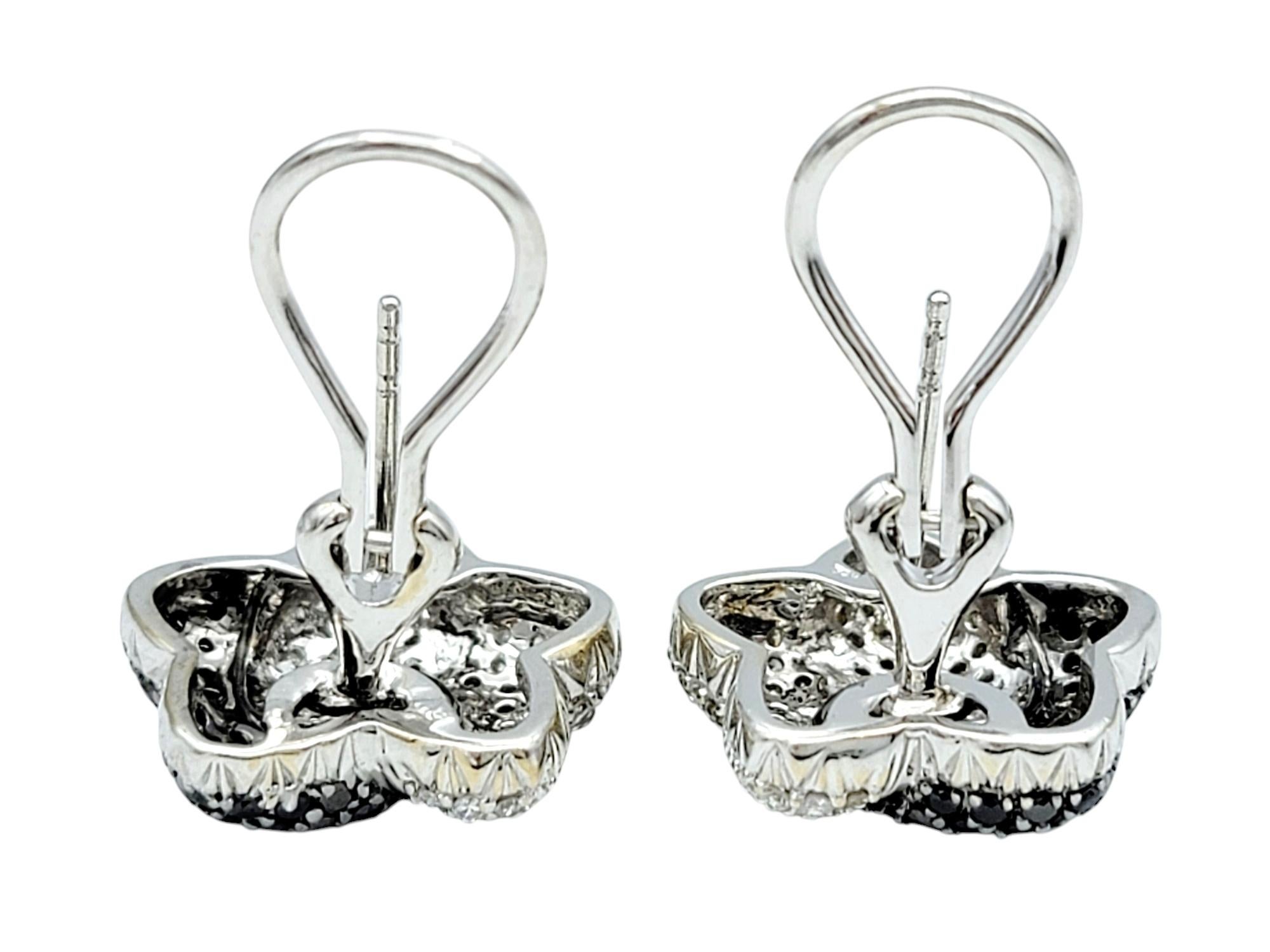 Round Cut Black and White Pavé Diamond Star Stud Omega Back Earrings 18 Karat White Gold For Sale