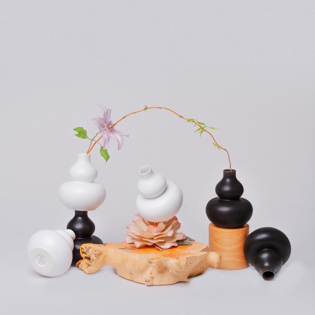 Middle Kingdom miniature porcelain vases are the perfect accent for any space. This broad collection interpreted in black and white creates a sculptural presence, yet can also contain a garden's worth of flowers. Let us choose ten pieces in this