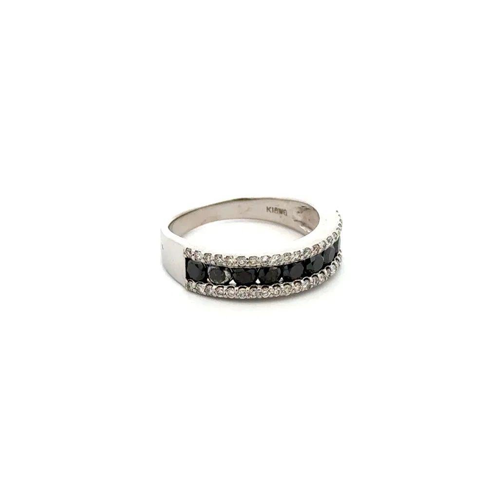 Black and White RBC Diamond Vintage Gold Band Ring Simply Beautiful! Black and White Diamond Band Ring. Centering securely Hand set Round Brilliant Cut Black Diamonds. Surrounded by White Diamonds. 1.05tcw of Diamonds. Hand crafted 18K White Gold