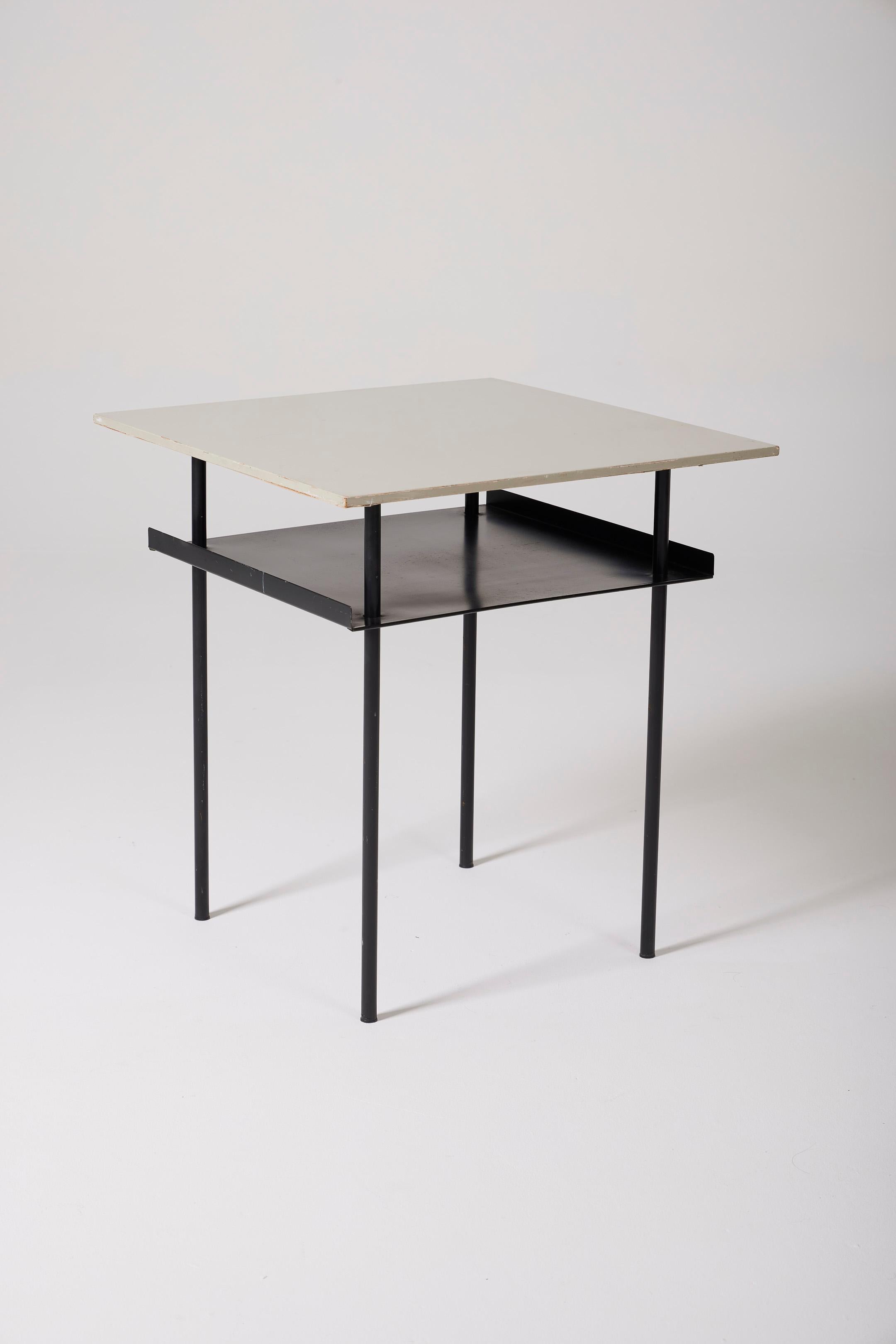  Side table by Dutch designer Wim Rietveld (1924-1985) in the 1950s. The table features a white lacquered wooden top and a black lacquered metal tubular structure. It includes an additional shelf under the top, making this coffee table very