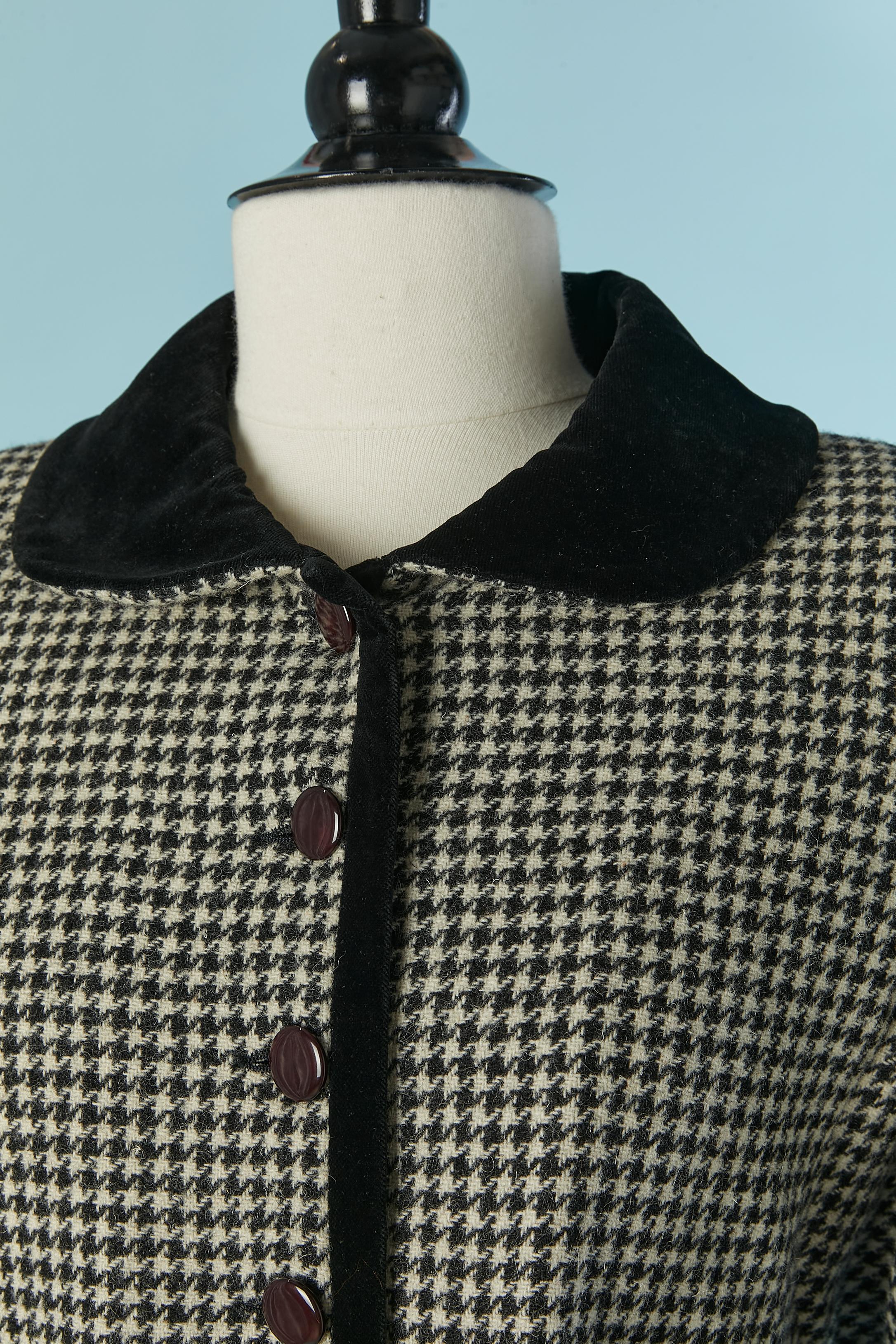 Black and white skirt suit with Pied de Poule pattern and black velvet collar. 
Main fabric: wool. Polyester or acetate  lining. The jacket is lightly padded. Button and buttonhole closure on the middle front. Pocket on both side with flap. Shoulder