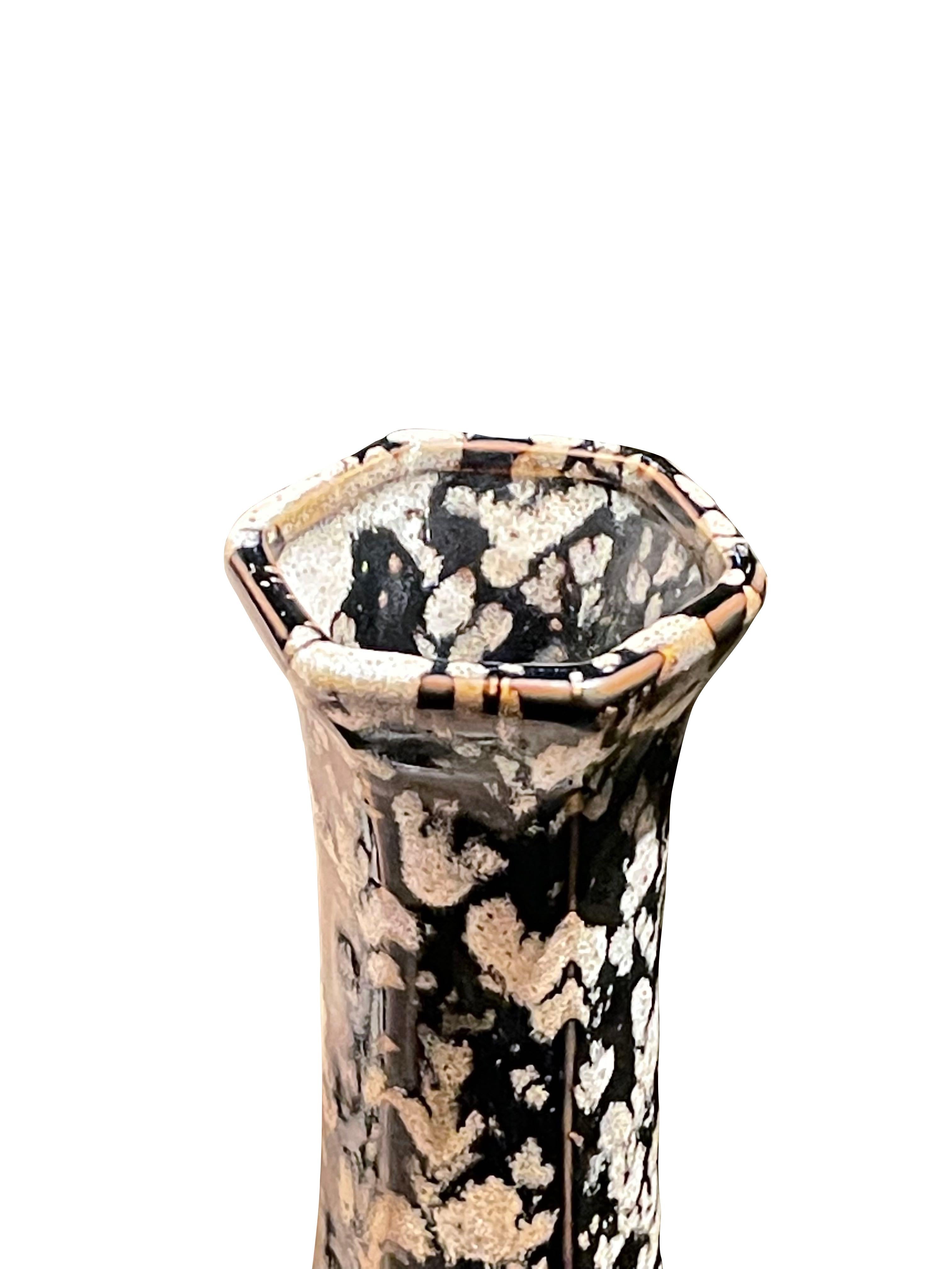 Contemporary Chinese tall thin vase with hexagonal shaped opening.
Black ground with white splatter glaze design.
Two available and sold individually.
