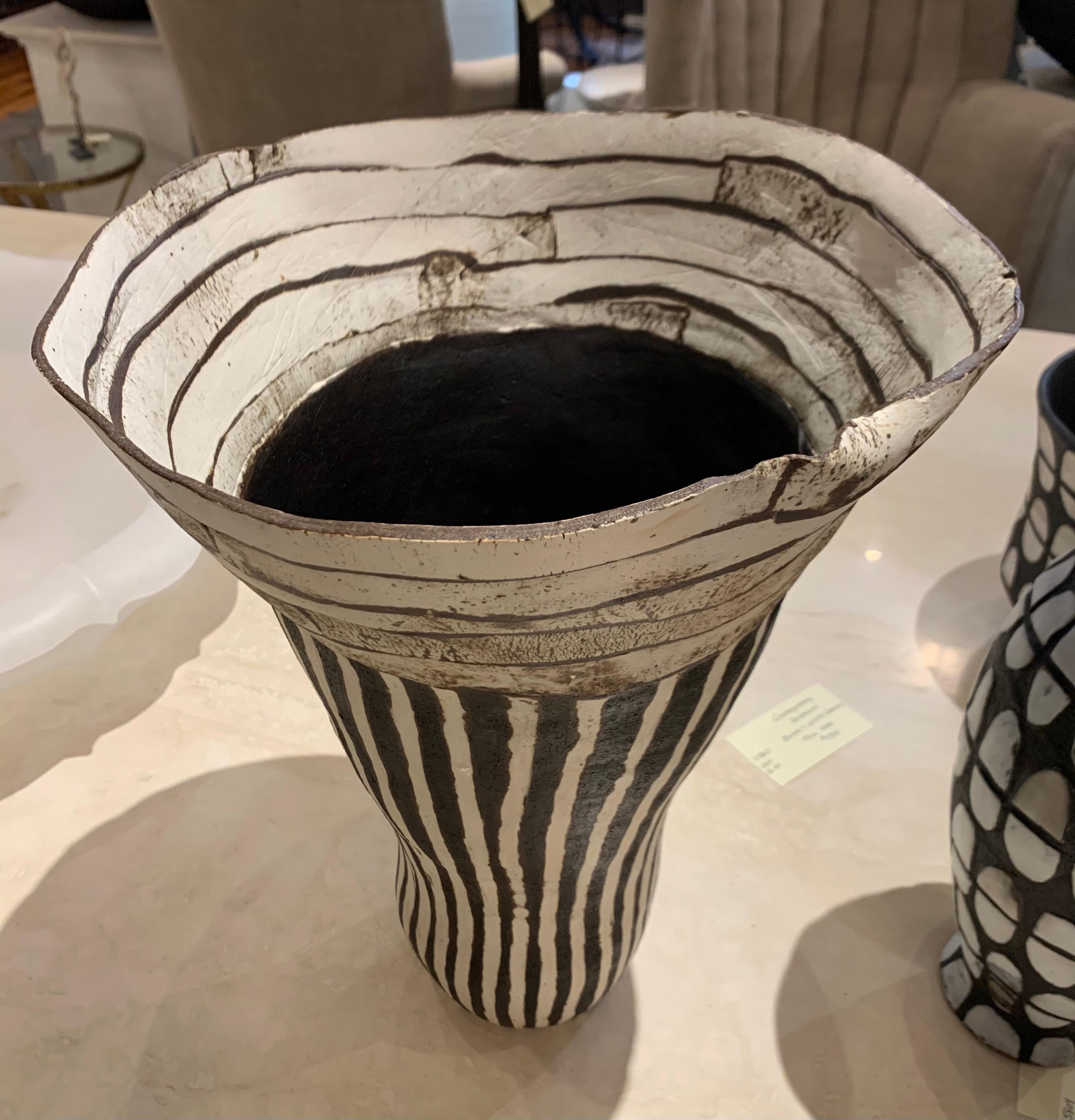 Contemporary American ceramicist Brenda Holzke hand made unique one of a kind tall ceramic vase that is hand built and made of dark stoneware and
porcelain slip. 
Wide organically shaped opening with horizontal stripes on the upper third and
