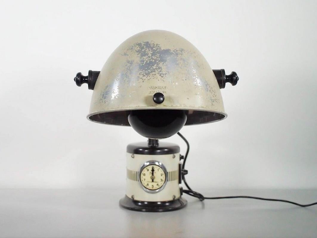 Rare vintage German sunlamp converted into a table lamp. White lacquered metal and black metal details. Adjustable light point. Wear consistent with age and use.