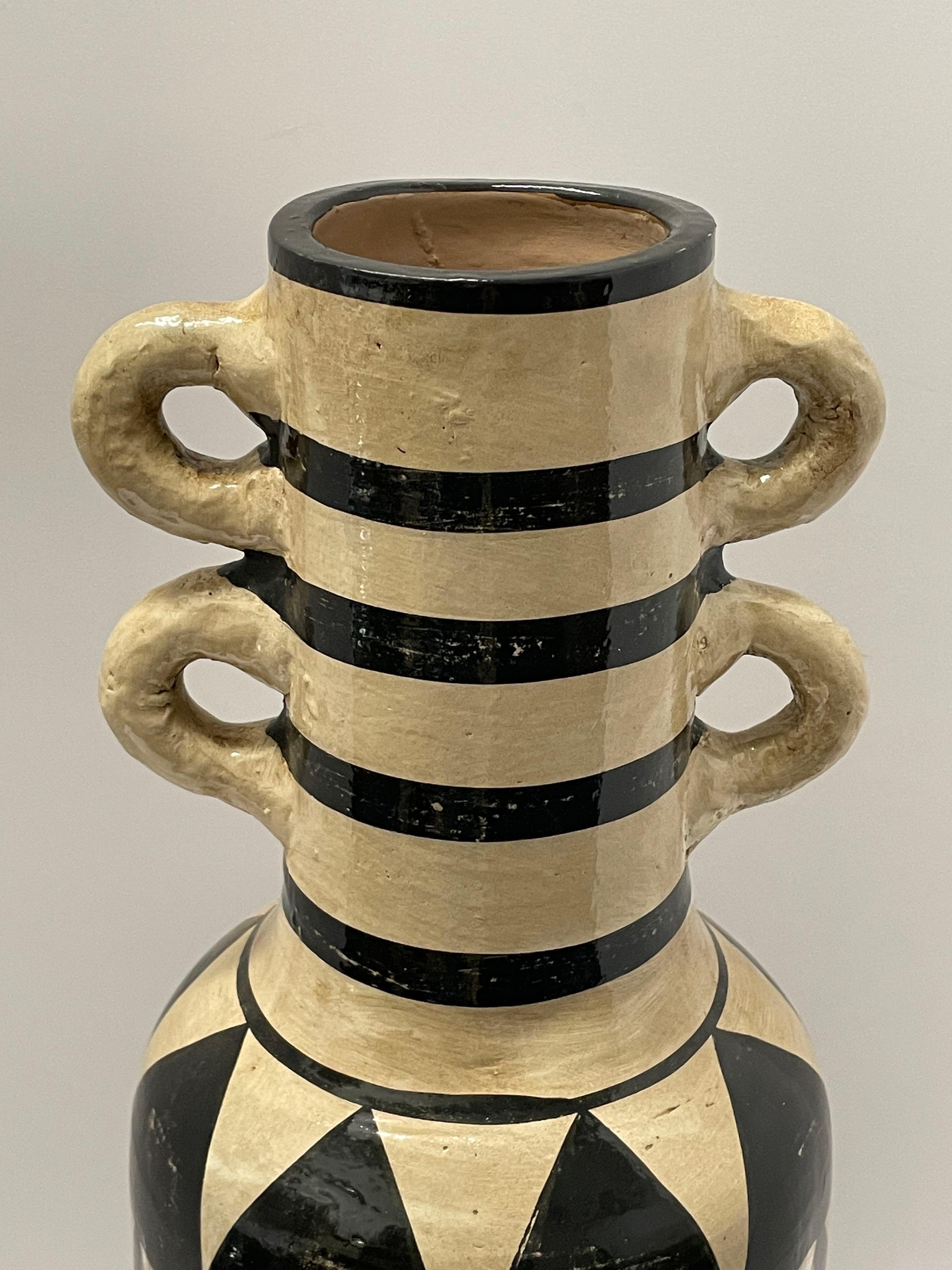 Contemporary Chinese tall black and white tribal pattern vase.
Decorative four handles with horizontal stripes at top and diamond pattern base.