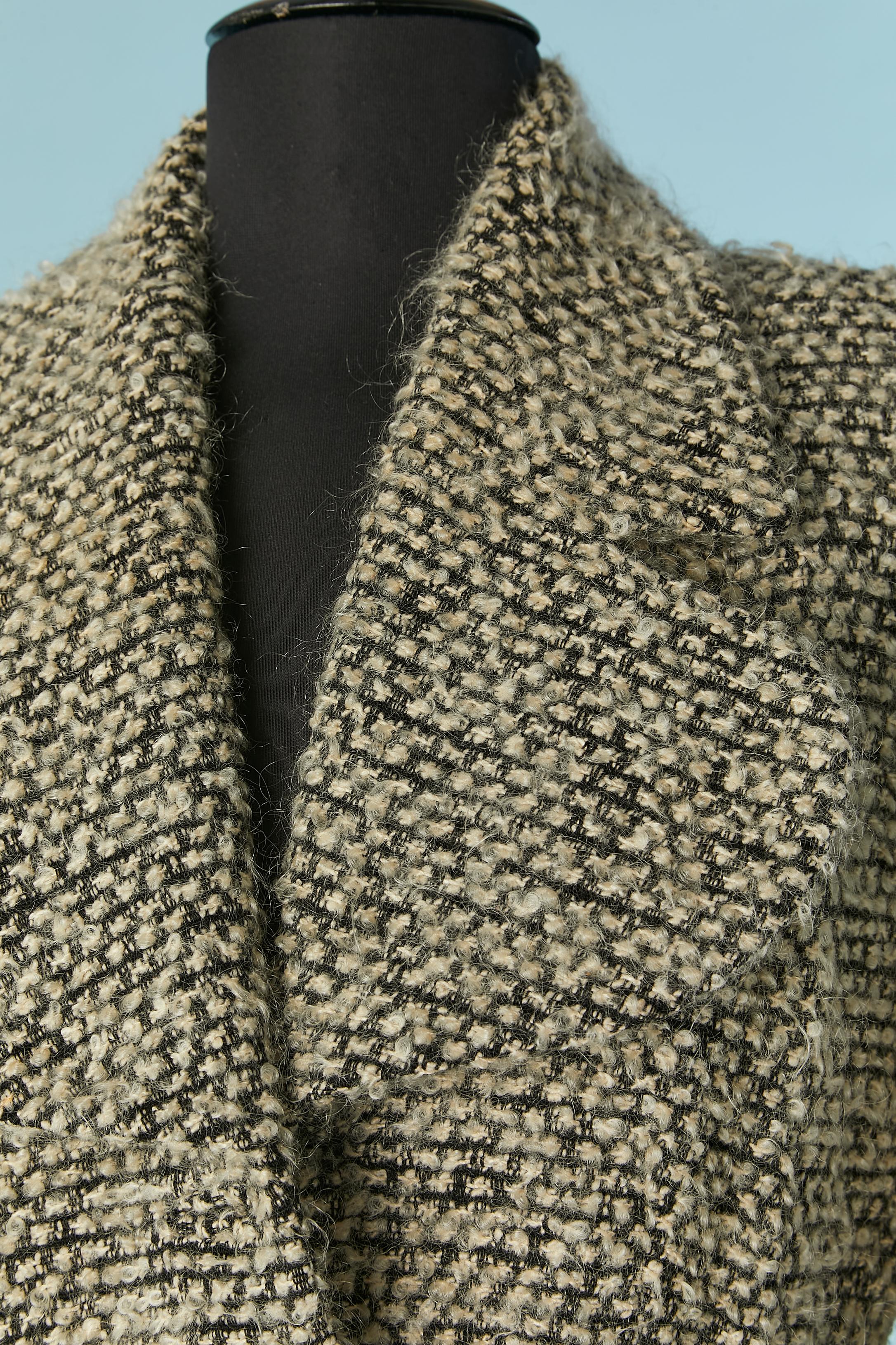 Black and white Tweed bouclette single breasted jacket. Main fabric composition: wool. Lining composition : acetate or rayon. 
Shoulder pad. Pocket on both side. 
SIZE 42 (Fr) L 