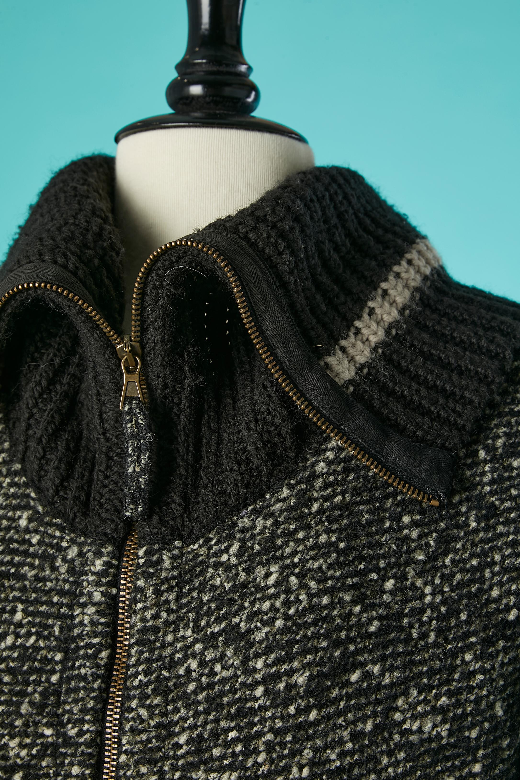 Black and white tweed short sleeves long jacket and wool rib-strips with zip in the middle front. 
Main fabric composition ( tweed) = 80% wool, 12% polyamide, 7% mohair, 1% other fibers. Ribs-strips insert= wool
Pockets on both side under the bust.