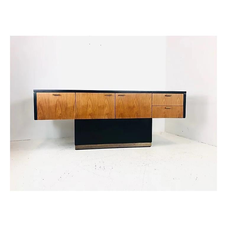 Vintage Mid-Century Modern black and wood front T-shaped console. Features brass accents.