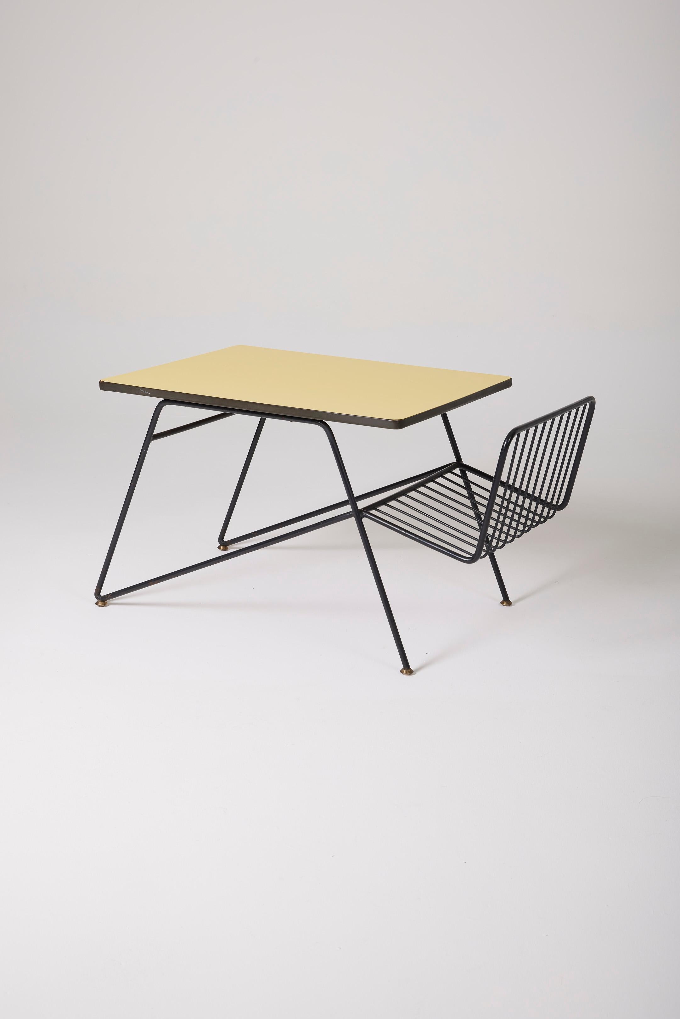 Coffee table by Italian designer Gastone Rinaldi (1920-2006) featuring a yellow Formica tabletop and a black tubular structure in the style of the 1950s. Includes a document holder on the side, making this coffee table a functional piece of