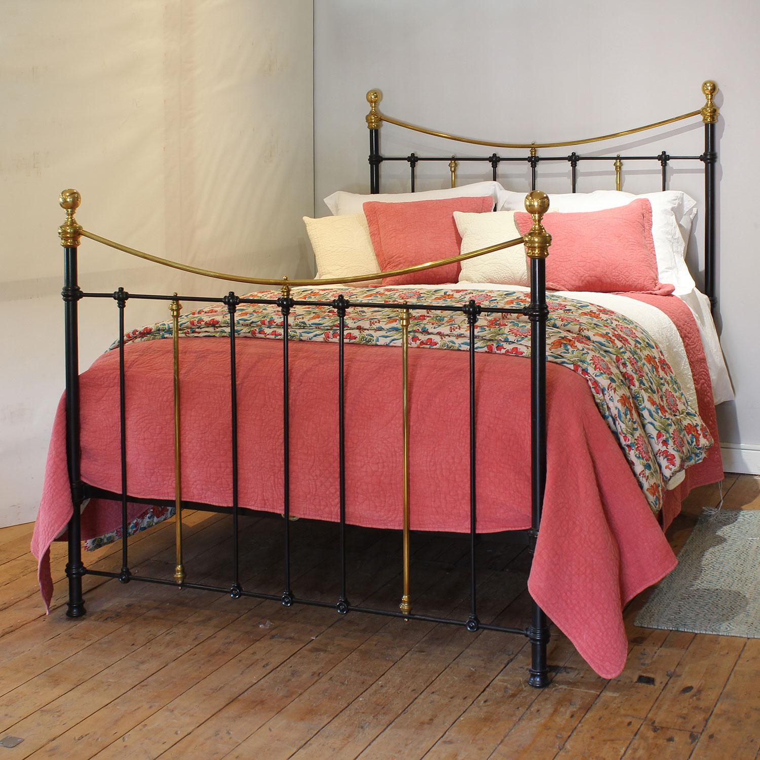 An attractive cast iron antique bed finished in black with curved brass top rails and simple castings.

This bed accepts a UK king size or US queen size (5ft, 60in or 150cm wide) base and mattress set.

The price includes a standard firm bed base to
