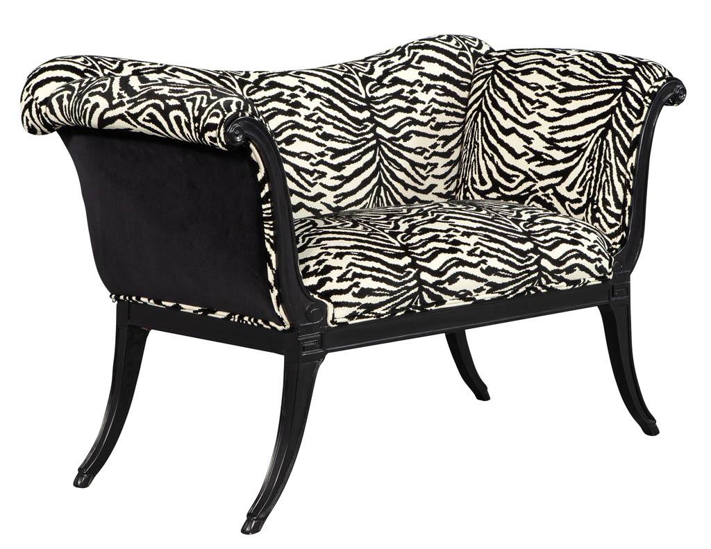 Restored antique settee bench. Upholstered in a faux animal print fabric and finished in an ebonized black lacquer.