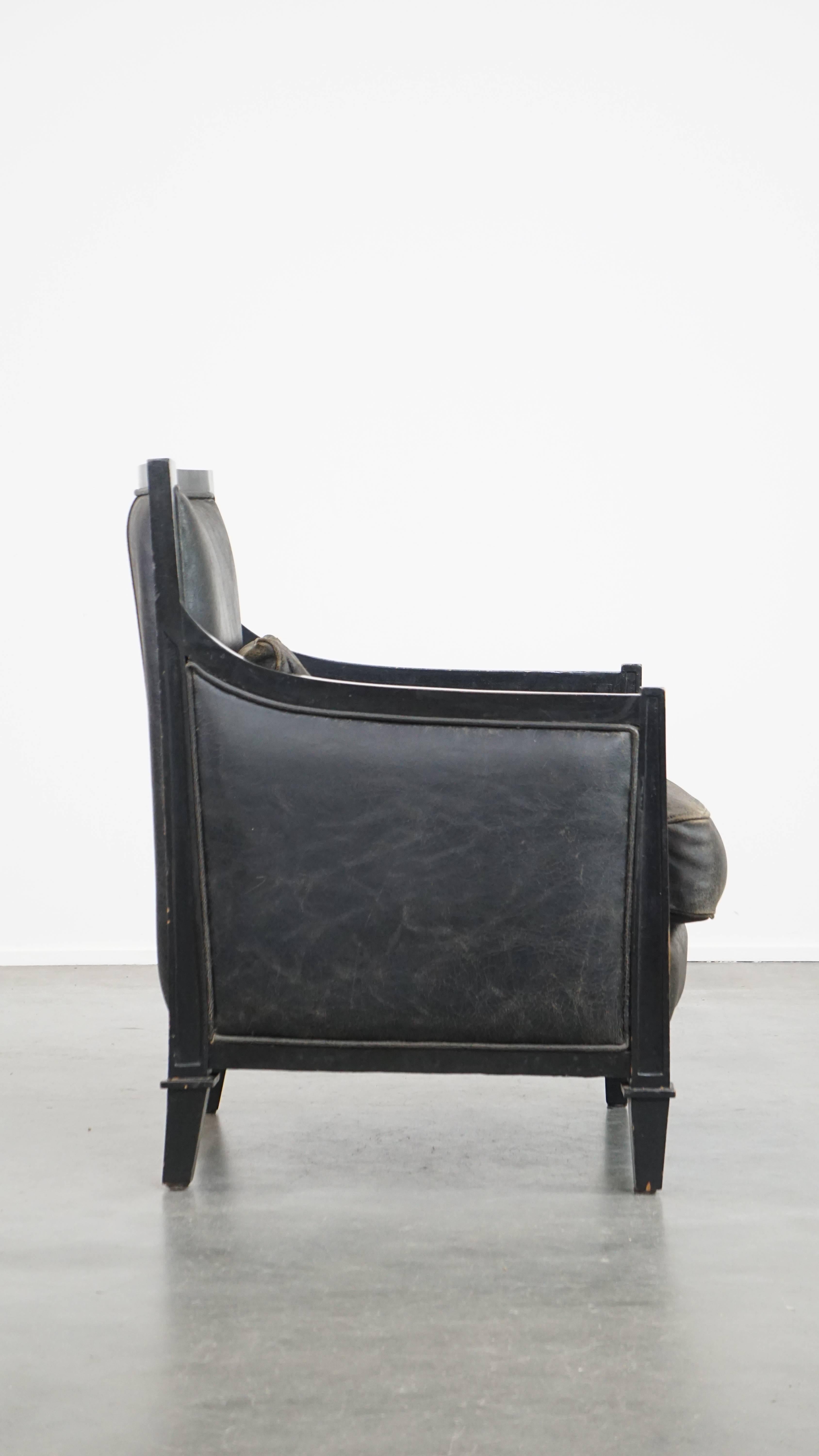 Hand-Crafted Black Art Deco design cowhide leather and wooden armchair with a loose cushion For Sale