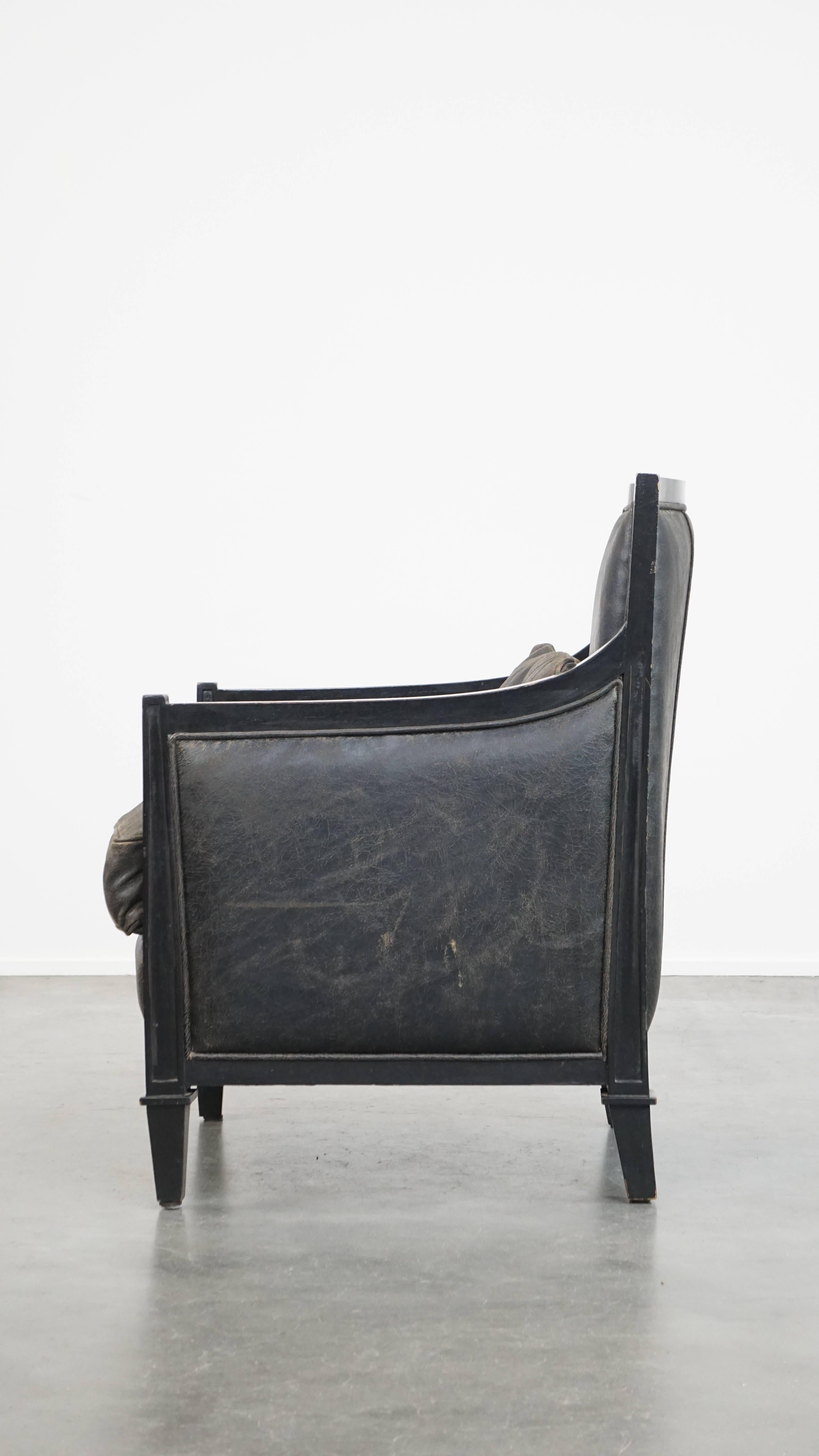 20th Century Black Art Deco design cowhide leather and wooden armchair with a loose cushion For Sale