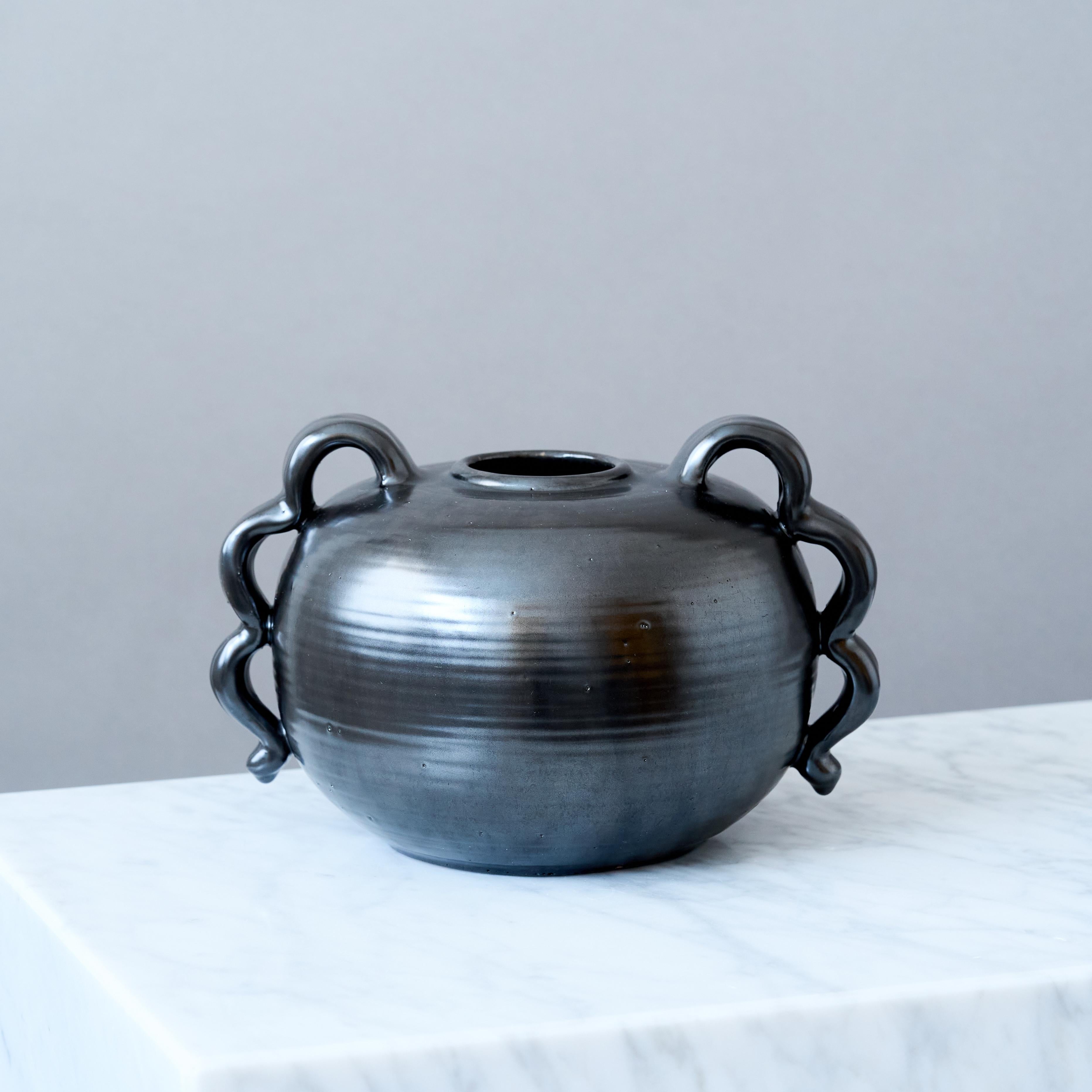 A beautiful Art Deco earthenware vase with amazing glaze.
Made by an unknown artist in Sweden, 1940s.

Signed with 'SWEDEN' and makers mark.
Good condition. A tint chip to the bottom rim (pictured).

