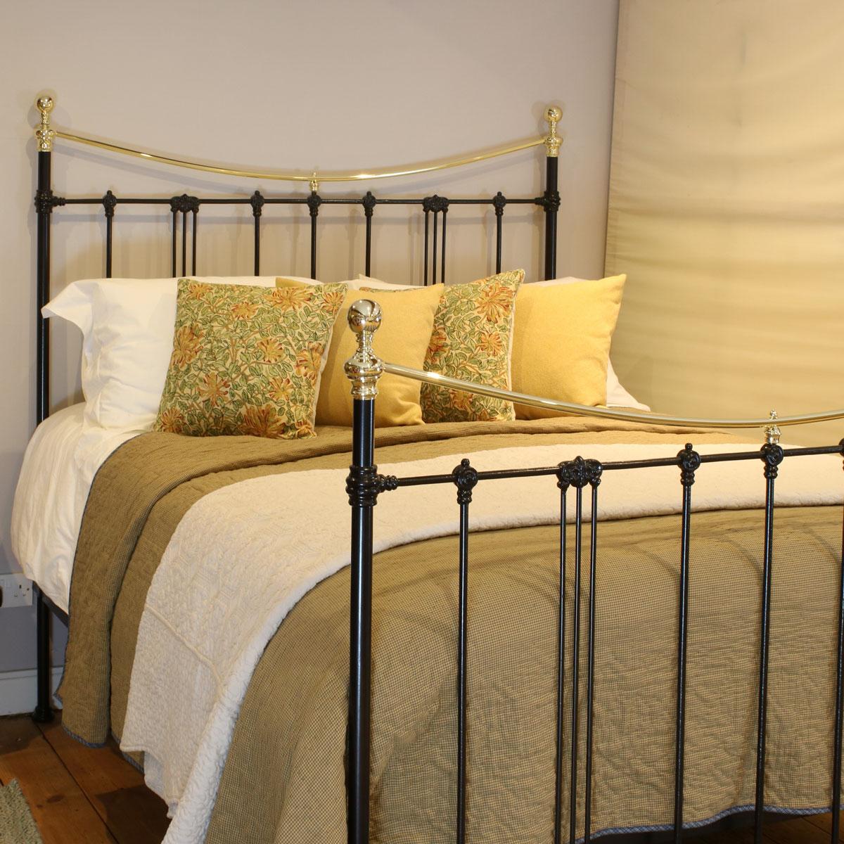 Victorian cast iron and brass bedstead in black with 'Art Nouveau' decoration and curved brass top rails. 

This bed accepts a UK King size or US Queen size (5ft, 60in or 150cm wide) base and mattress set.

The price includes a standard firm bed